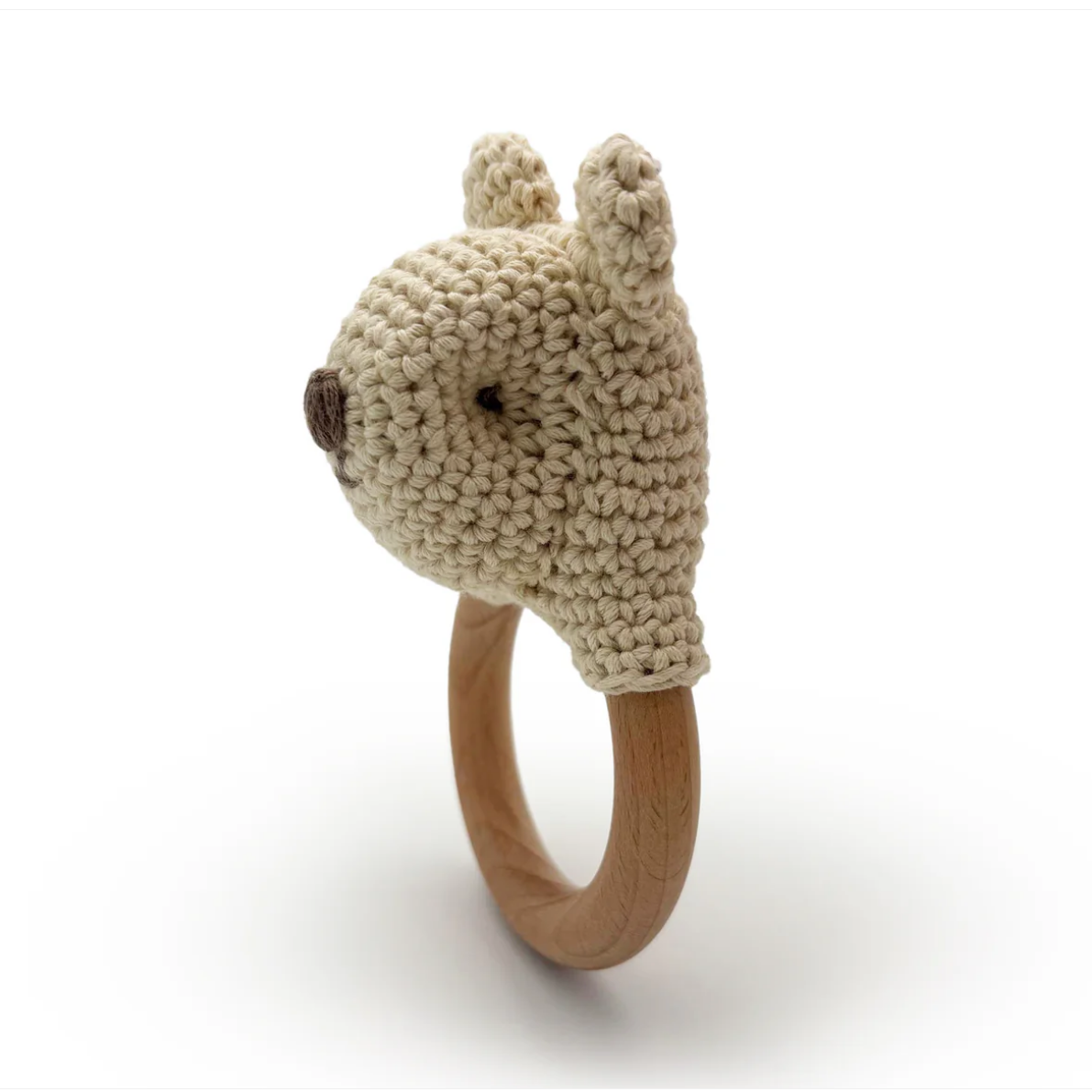 Knitted animal head on a wooden ring with a white background