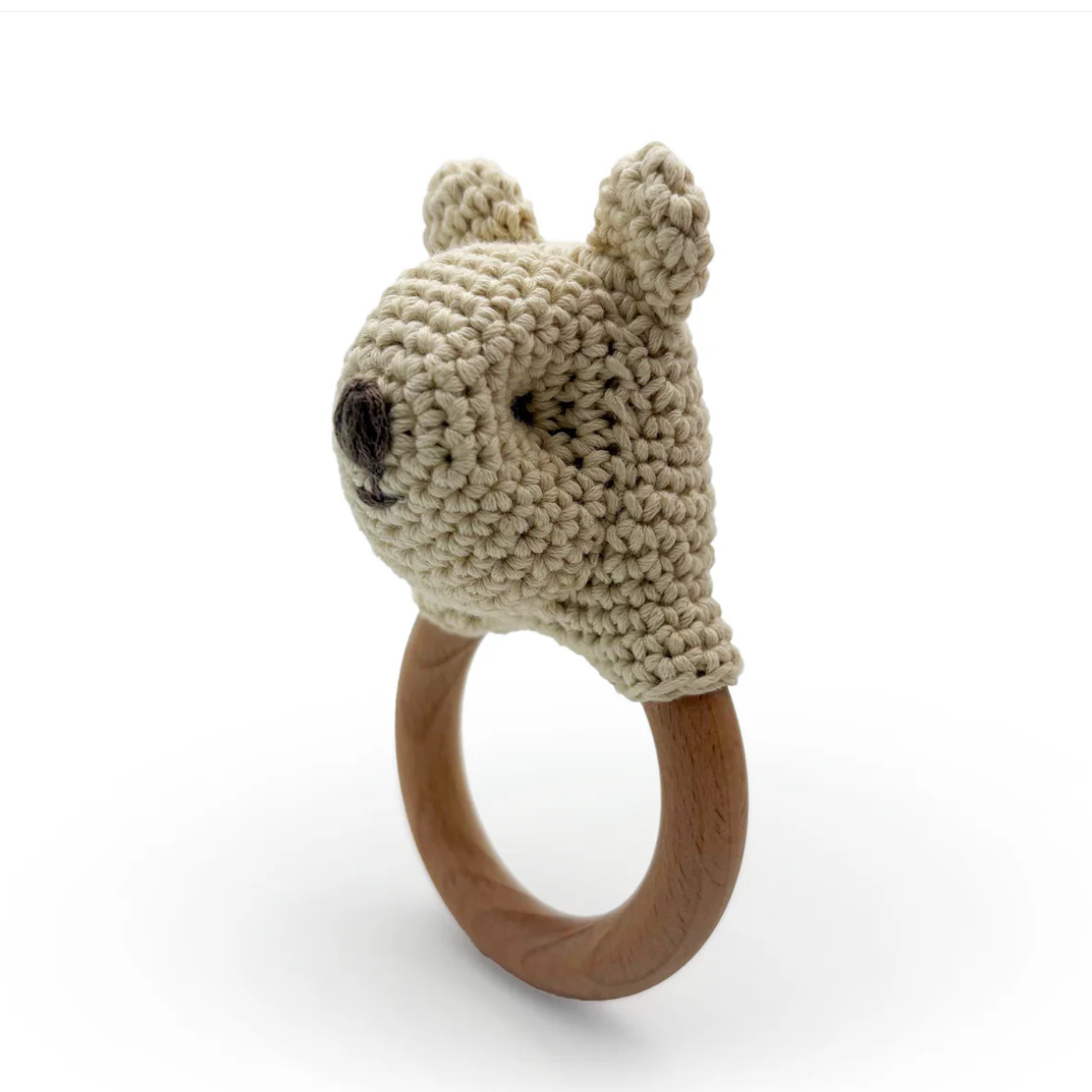 Knitted animal head on a wooden ring with a white background
