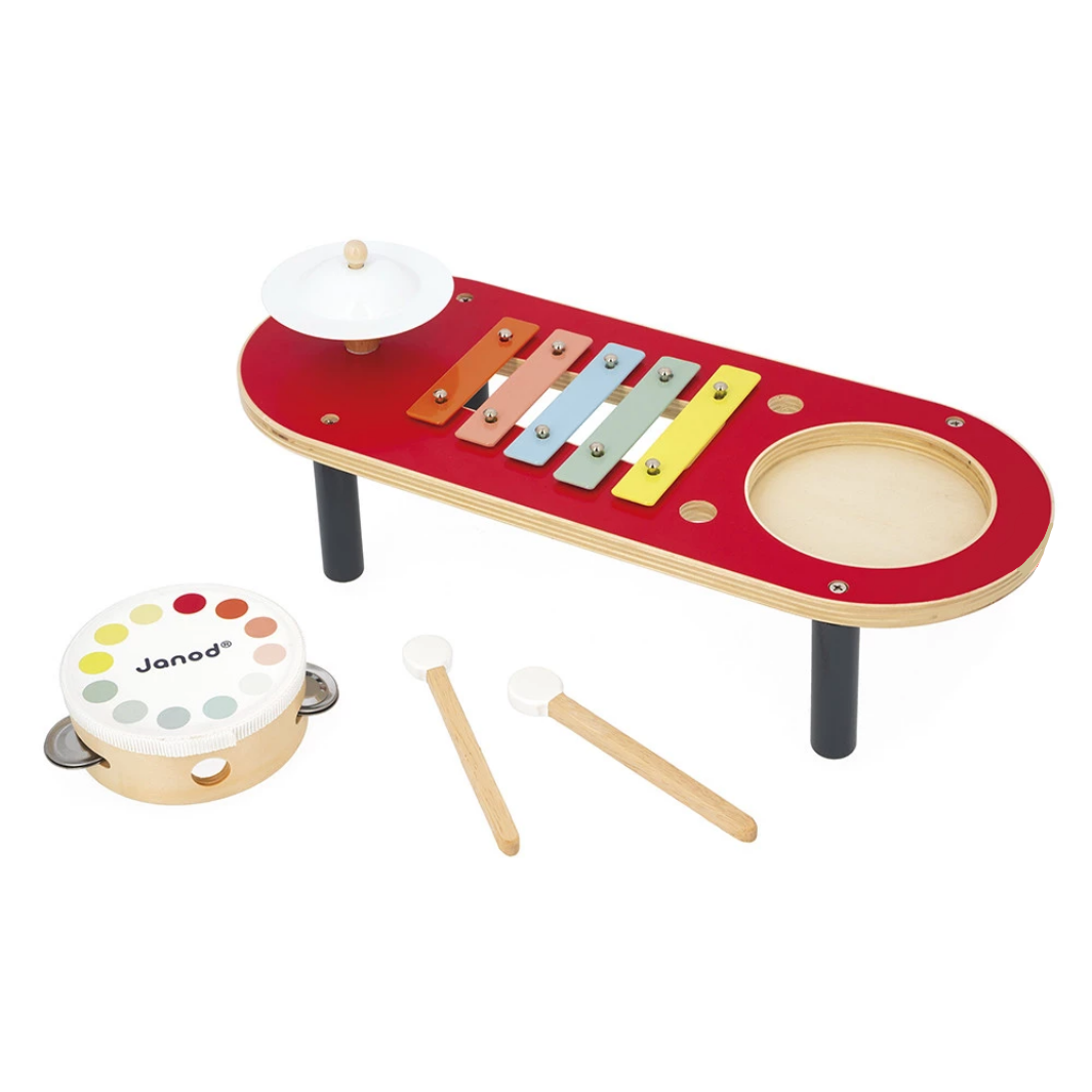 Children's musical instrument set with a red platform, xylophone, tambourine, and mallets on a white background.