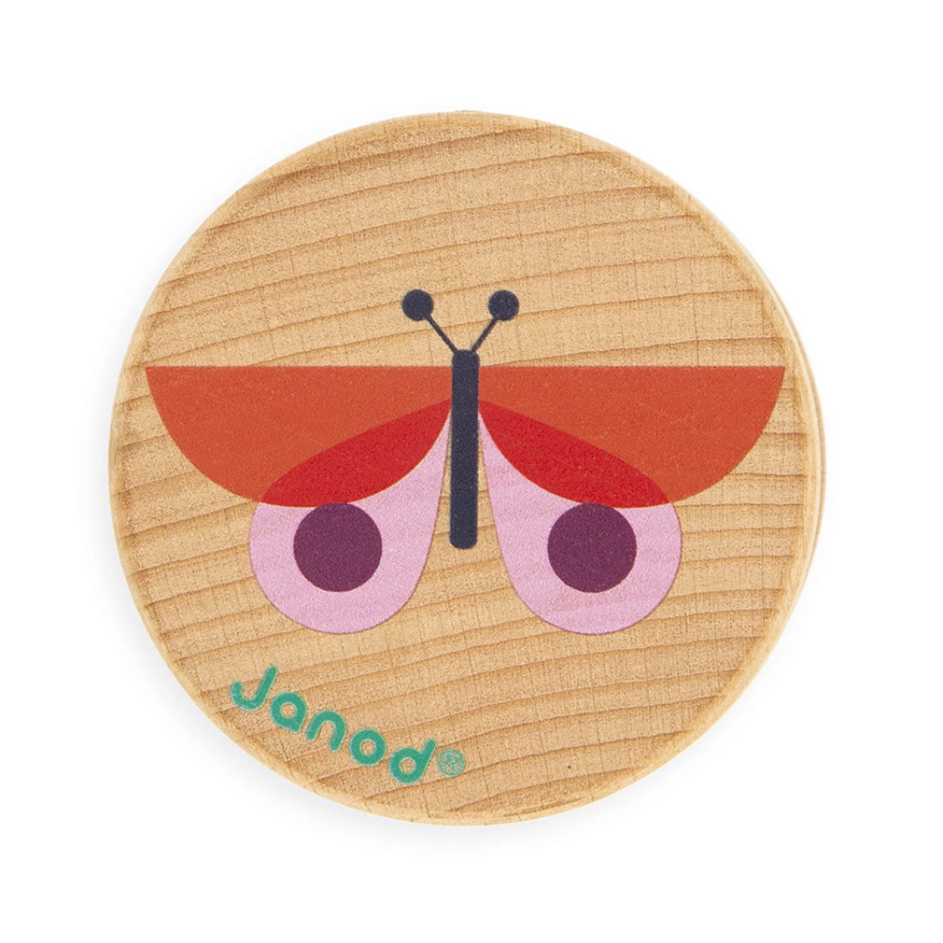 Wooden toy butterfly with red wings and black body on a wooden base, branded 'Janod'.