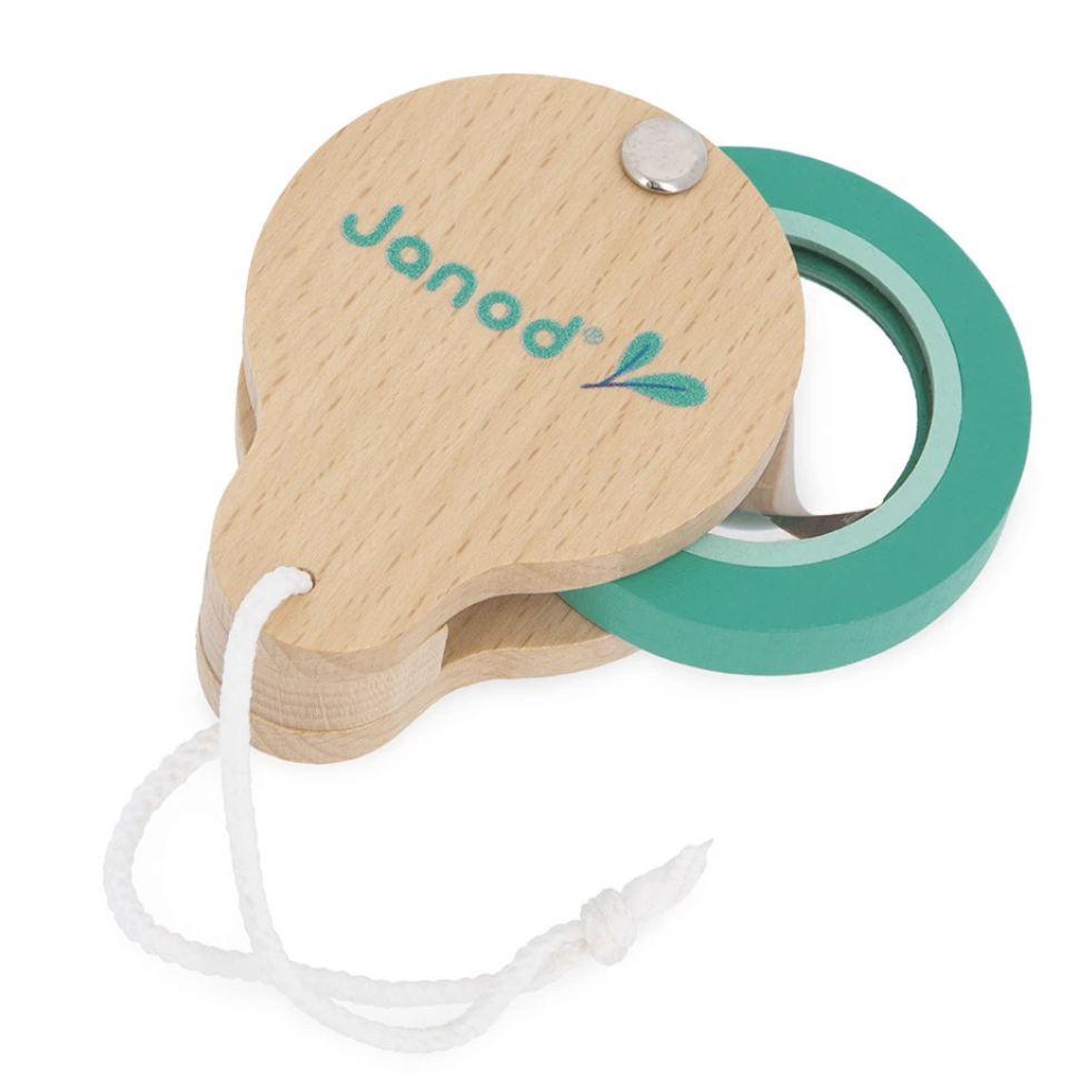 Wooden magnifying glass with teal lens and 'Janod' branding on a white background
