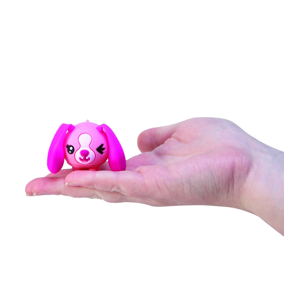 Pink toy with bunny ears held in a hand on a Schylling website page.