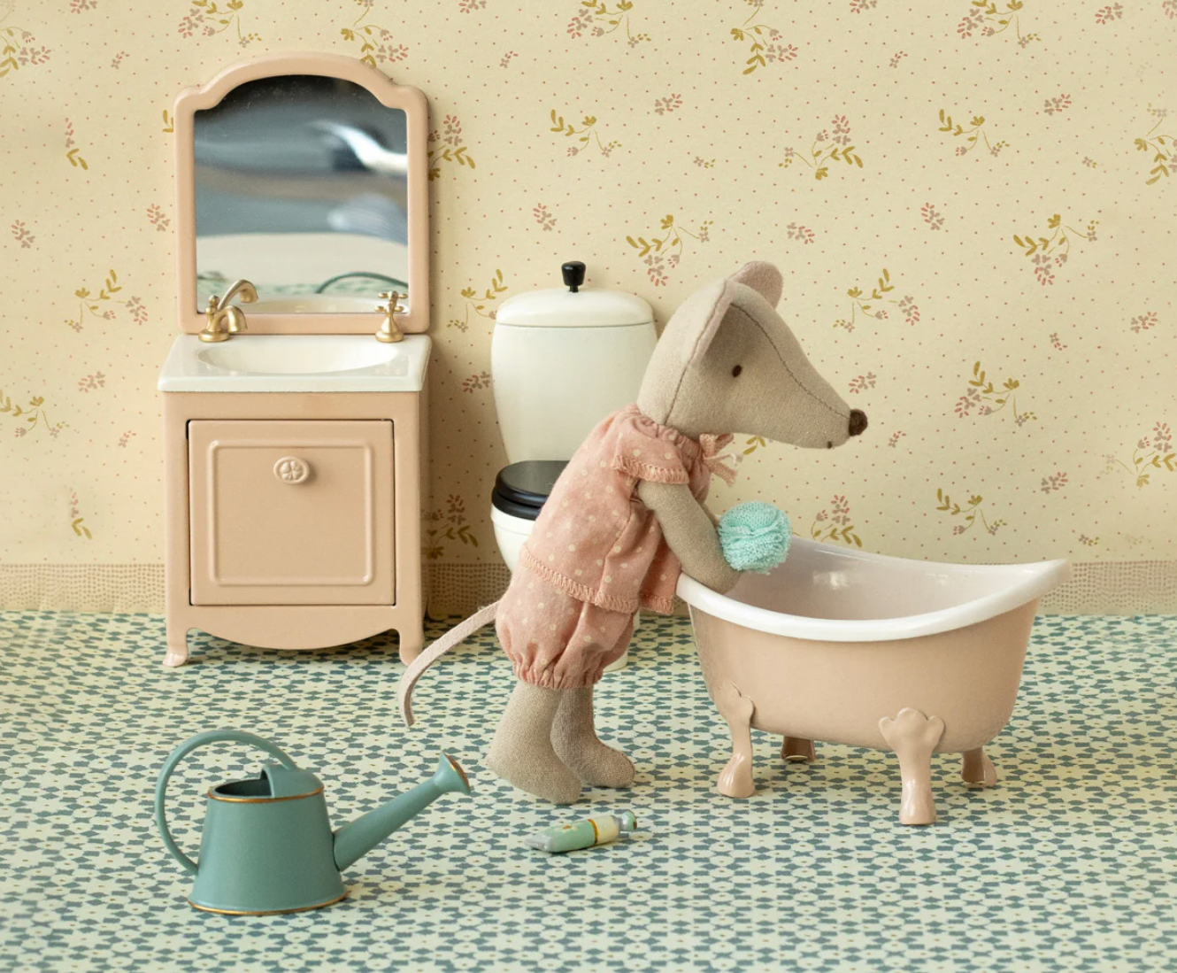Toy mouse in a bathtub with bathroom furniture and decor in the background