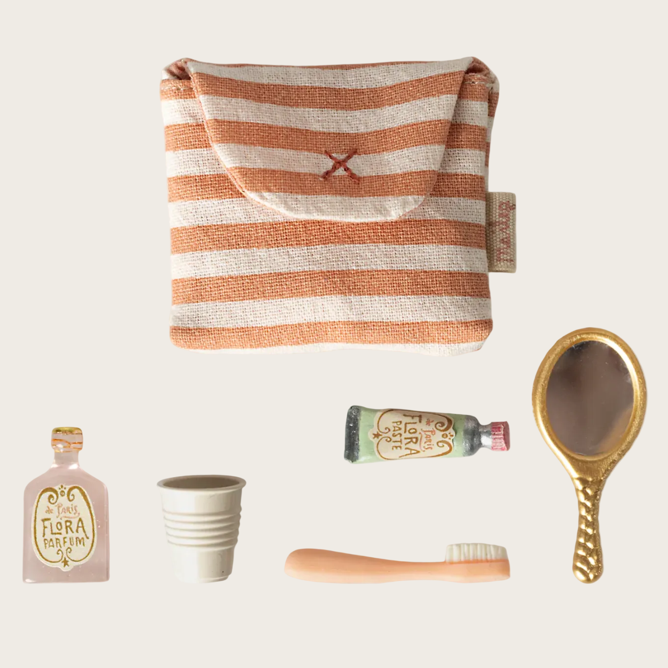 Product page with striped pouch, toothbrush, and other items on a white background