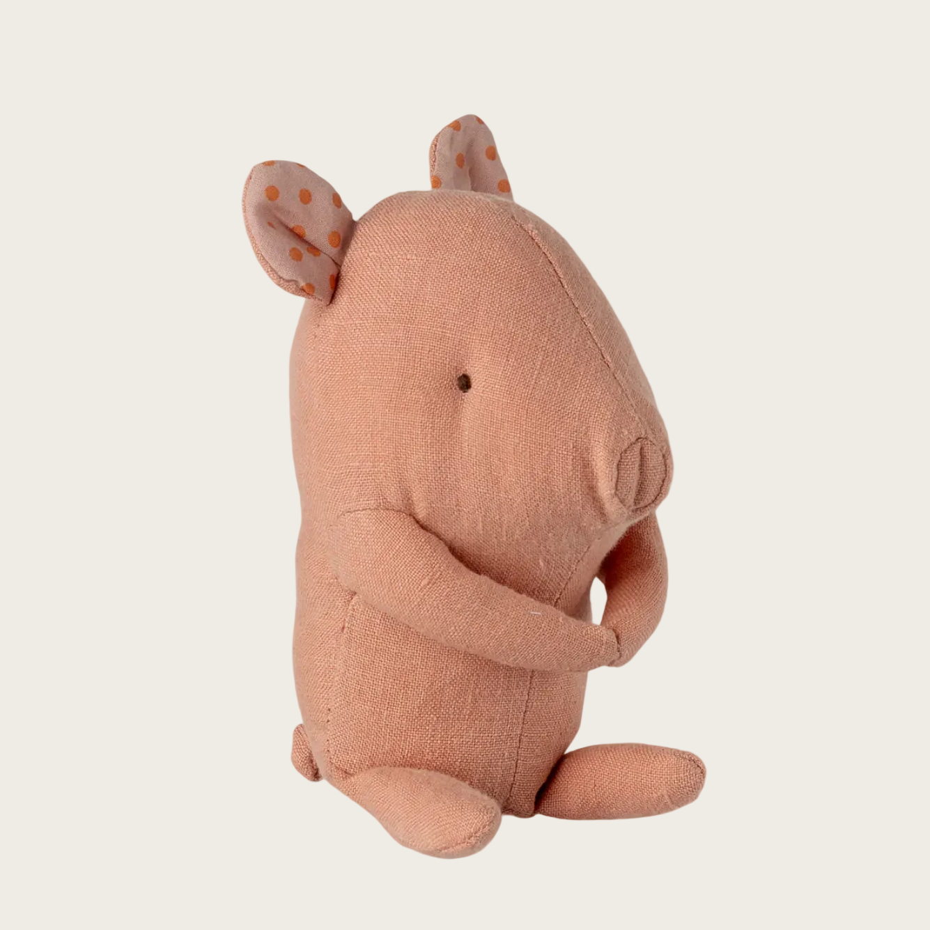 Pink plush pig  on a light beige background