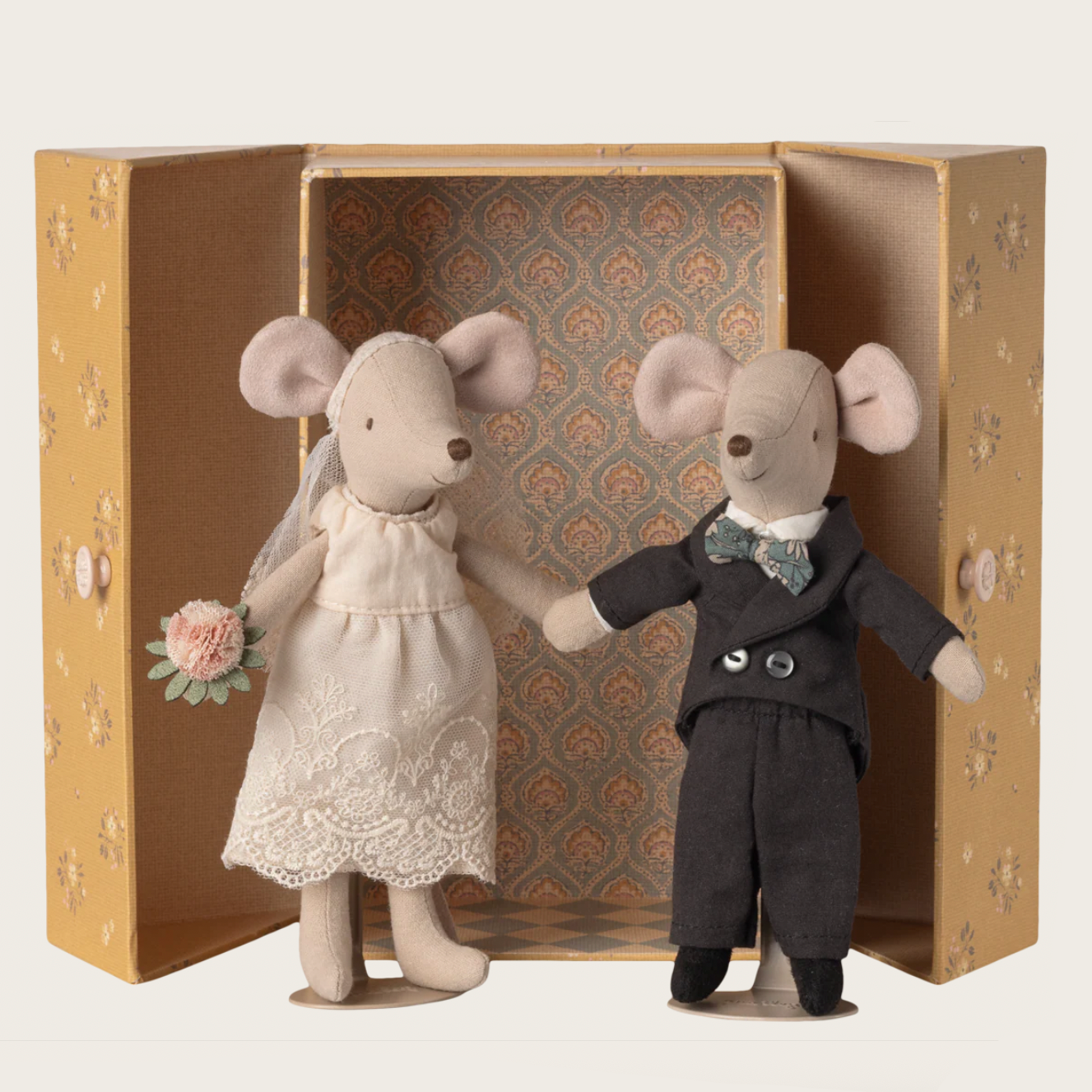 Two toy mice, one in a dress and the other in a suit, in a decorative box 