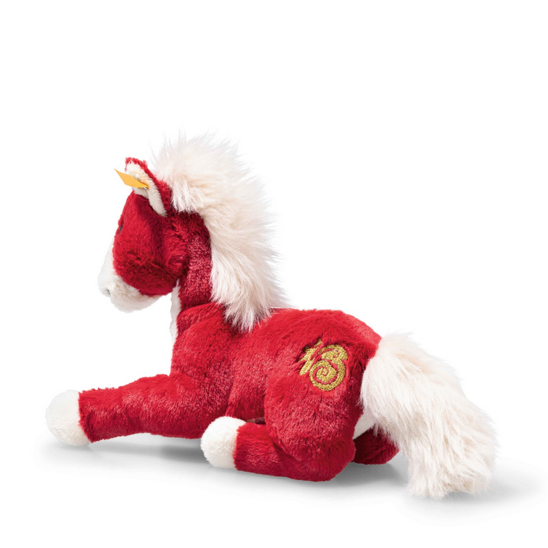 Red plush toy horse with a white mane on a white background
