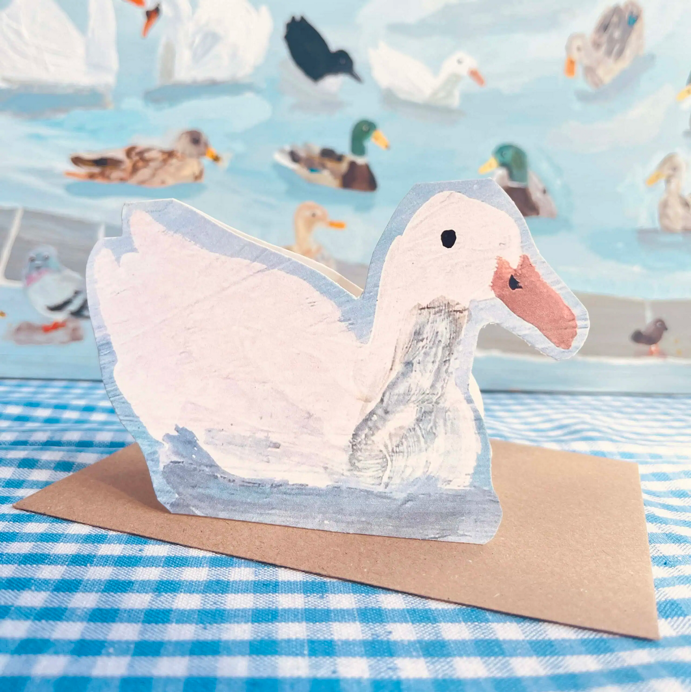 Card with a duck card on a blue checkered background
