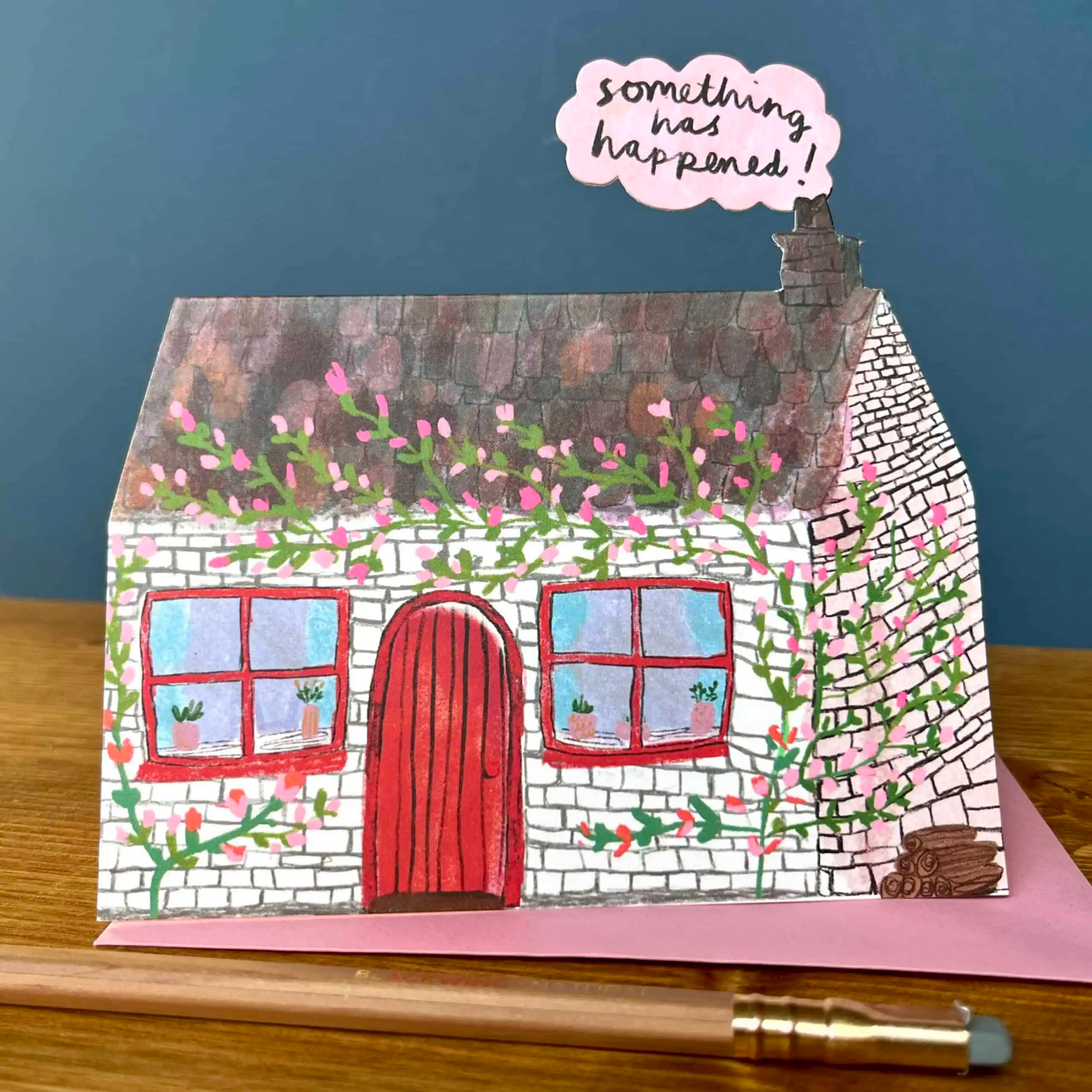 Card with a house illustration and text 'something has happened!' on a blue background