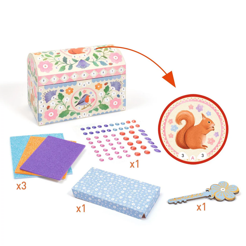 Children's craft kit with a decorative box, paper, and other materials on a white background.