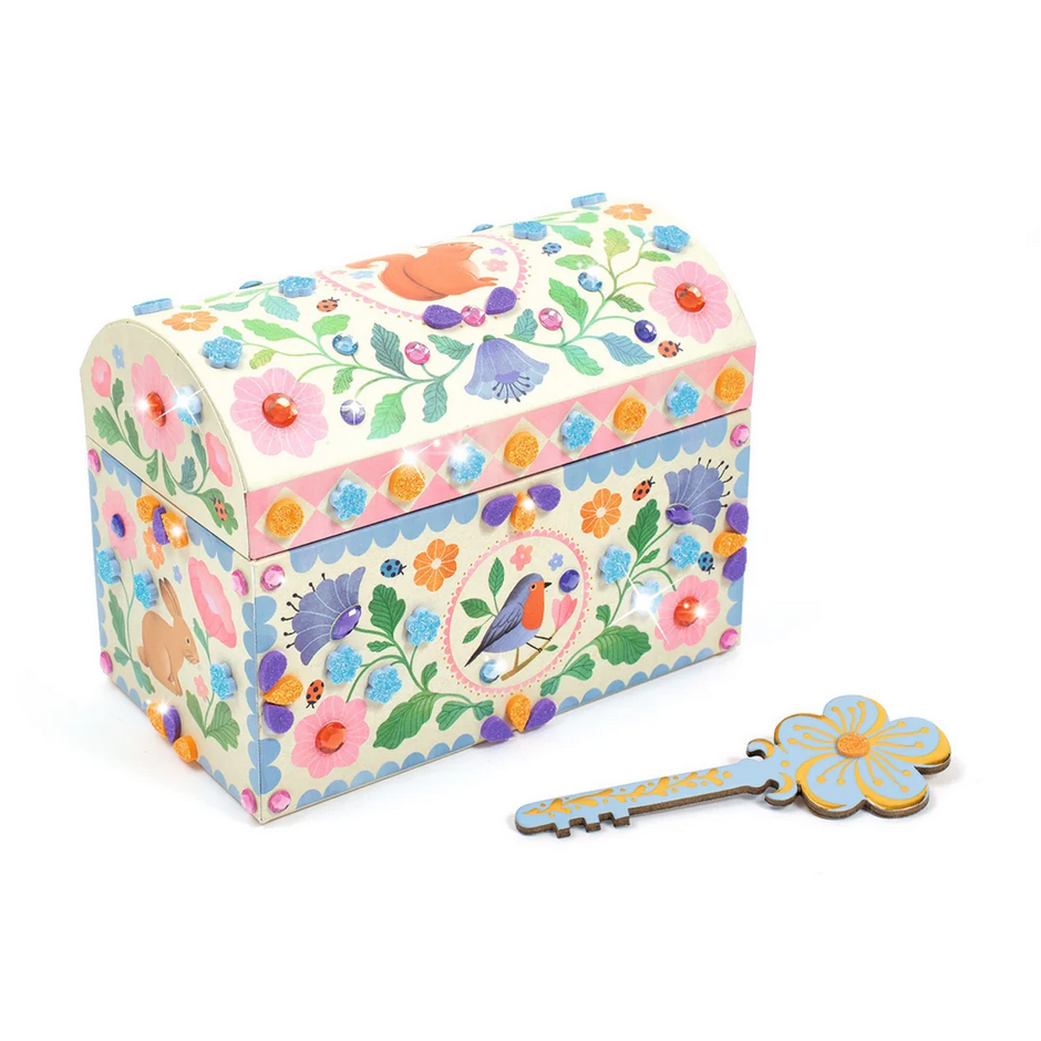 Decorative jewelry box with floral pattern and matching key on a white background
