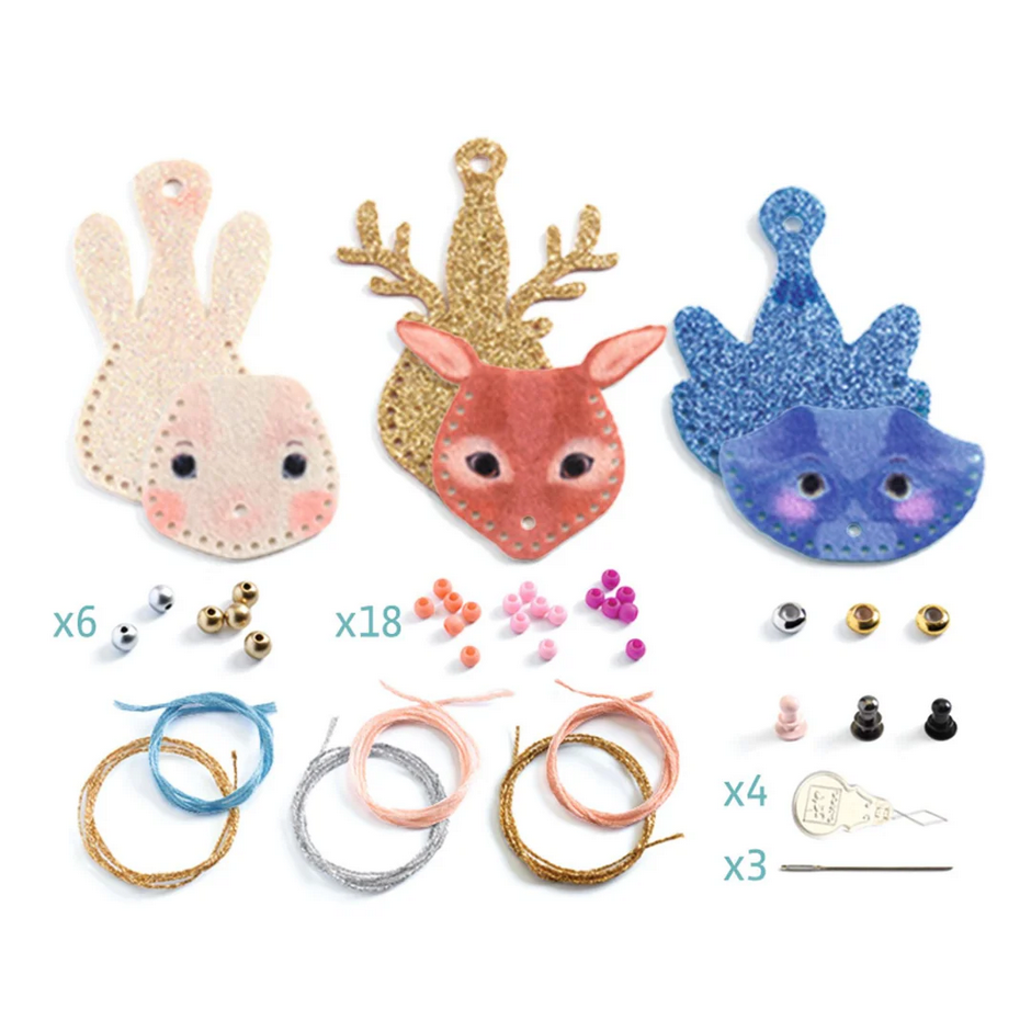 Decorative animal head ornaments with accessories on a white background