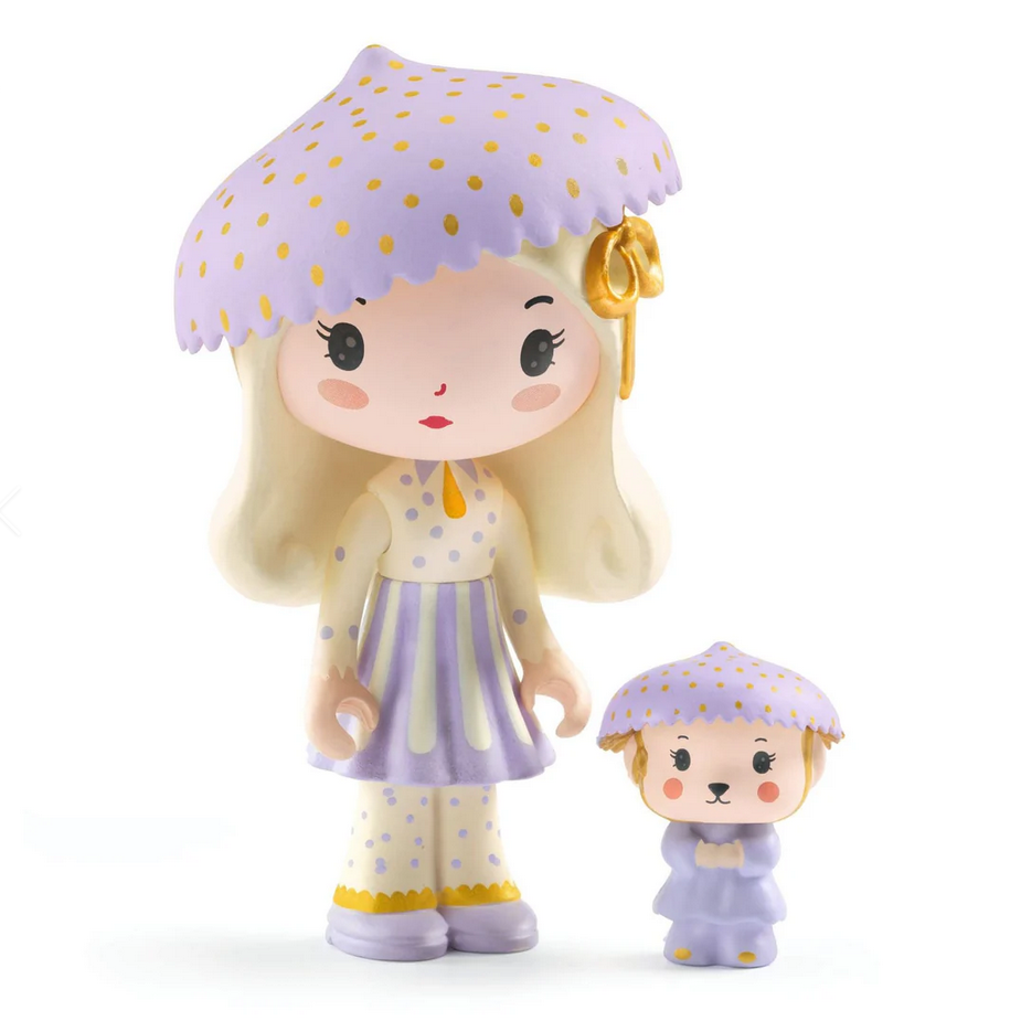 Two figurines, one larger and one smaller, both wearing purple outfits with polka dots on a white background.