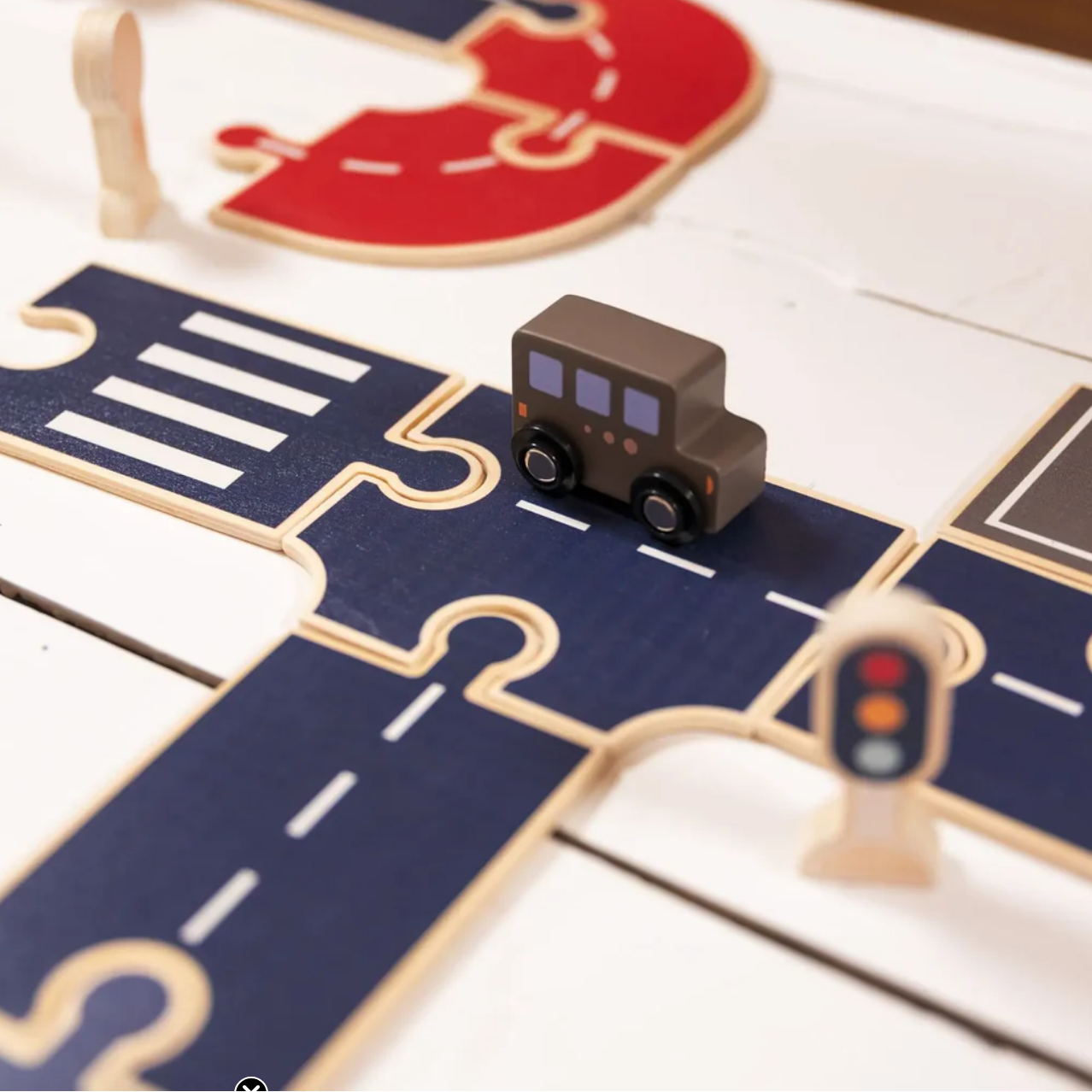 Toy truck on a wooden road track with a traffic light