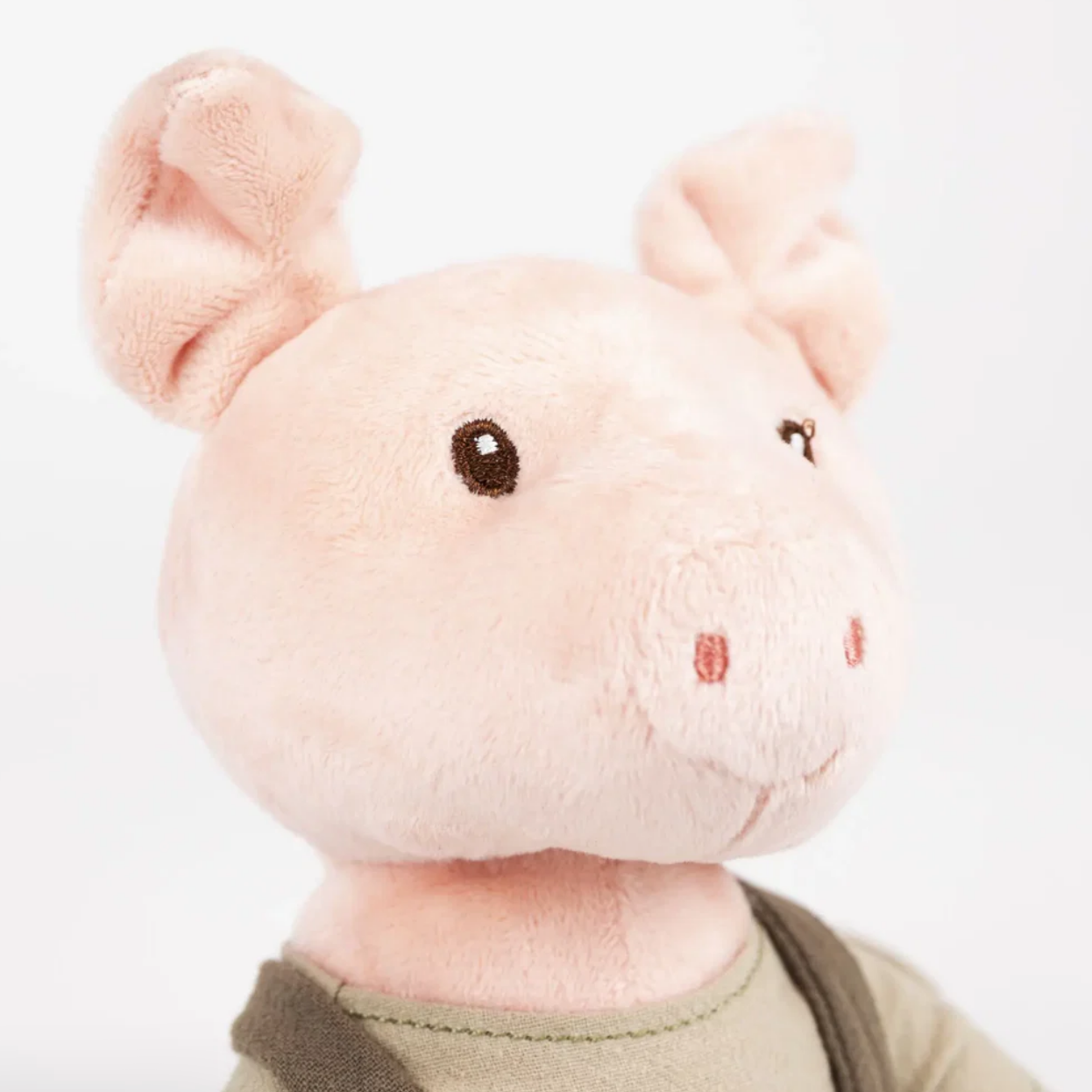 Plush toy mouse with a green shirt on a white background
