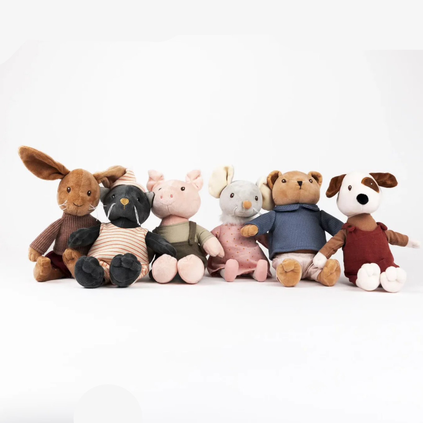 Set of plush toys resembling a rabbit, bear, pig, and dog on a white background