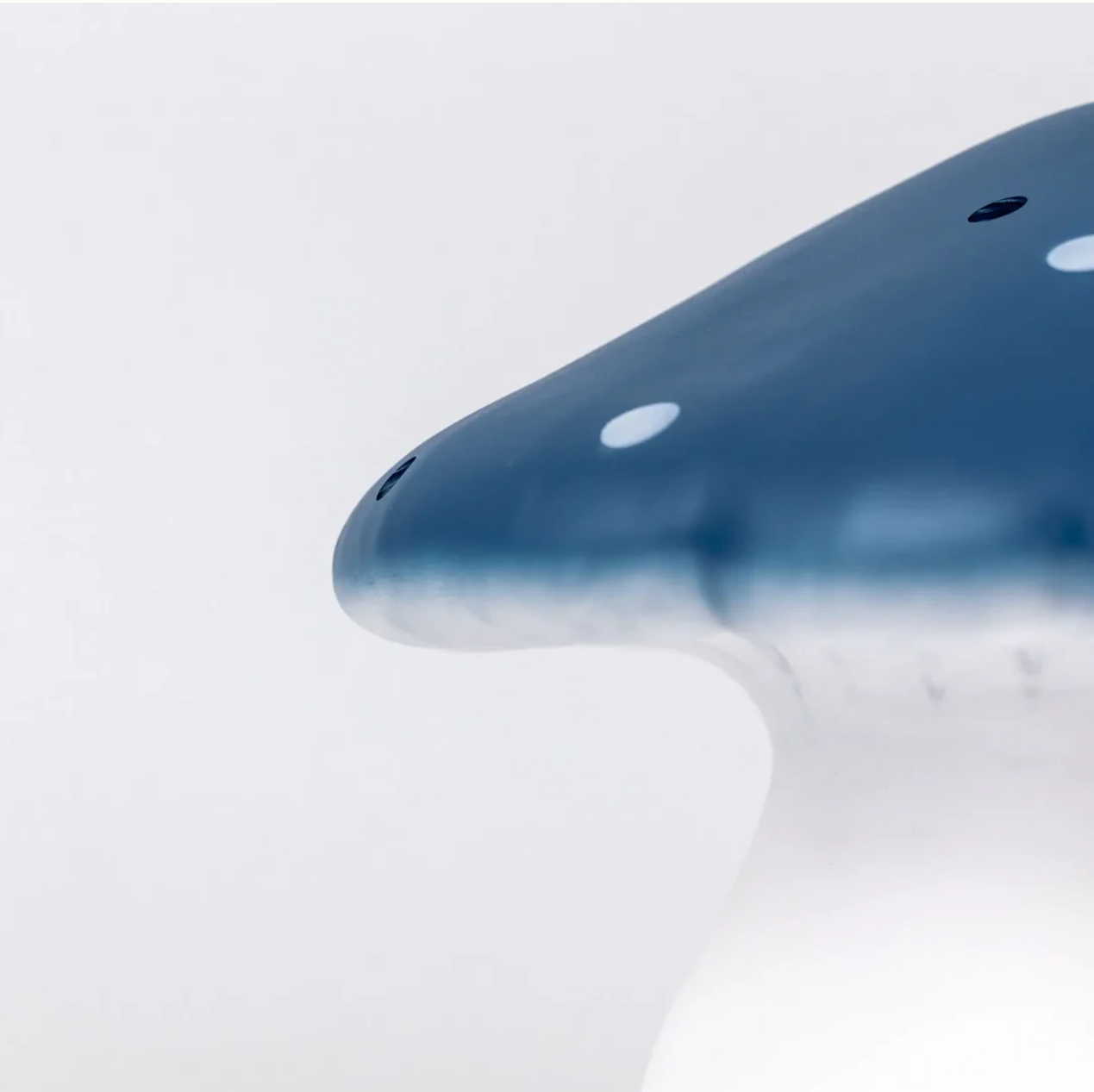 Close-up of a blue lamp with a white background