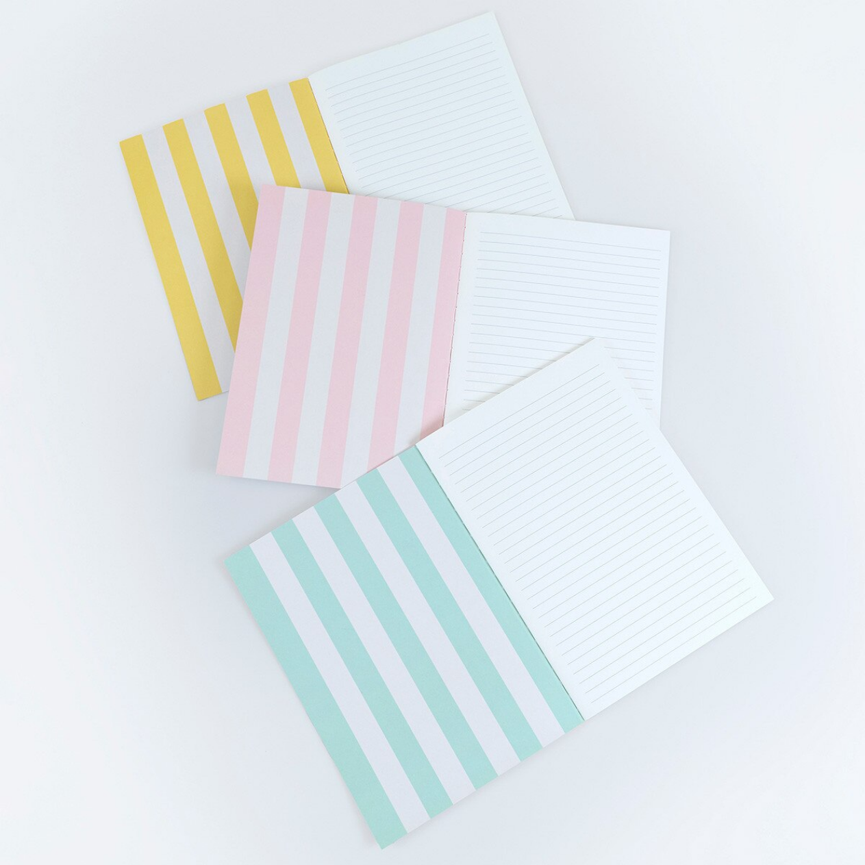 Set of stationery items including striped cards and an envelope on a white background