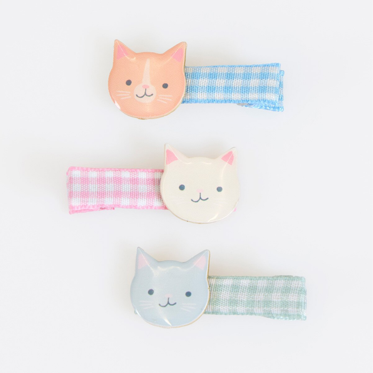 Set of three cat-shaped hairbands with checkered straps on a white background