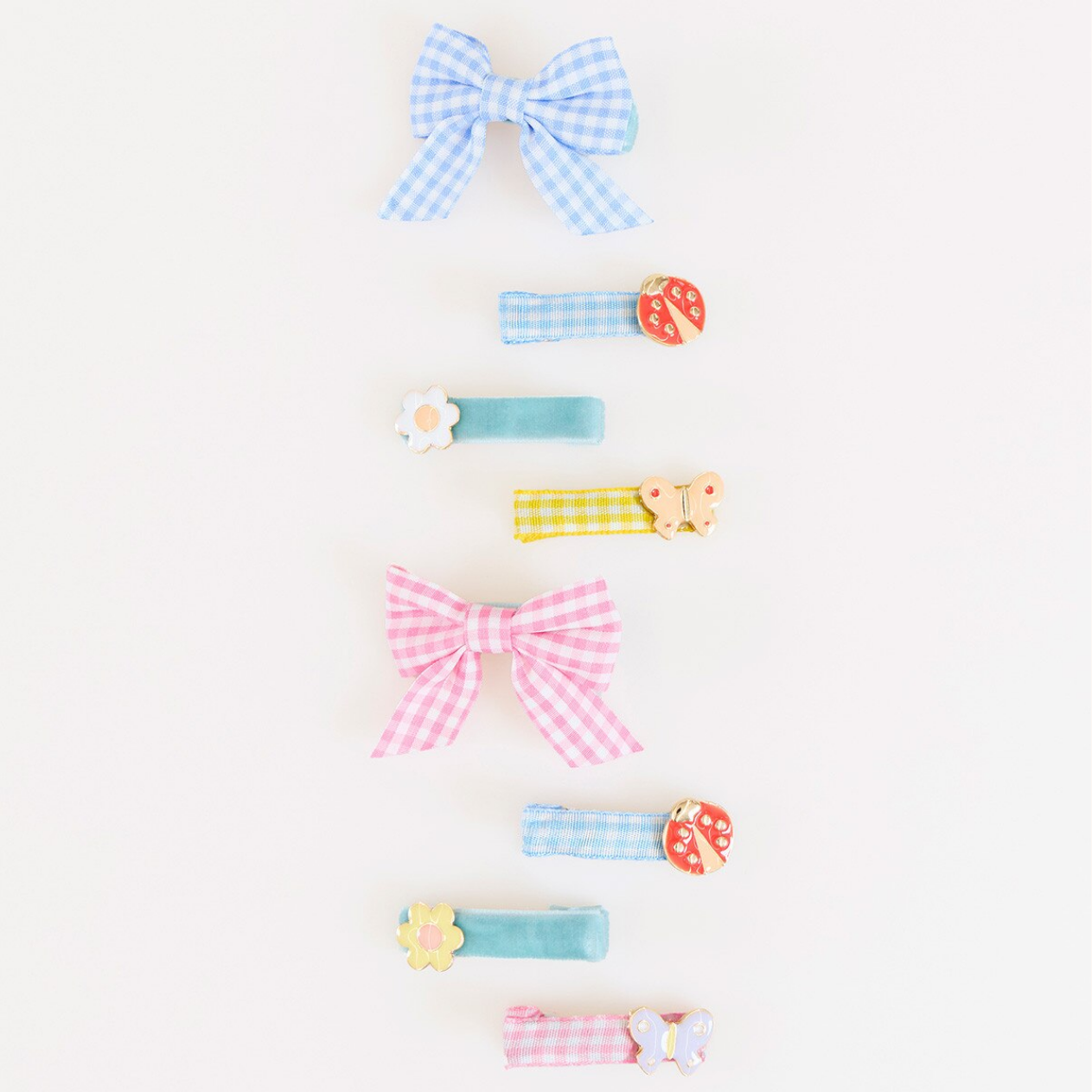 Set of colorful hair accessories including bows and clips on a white background