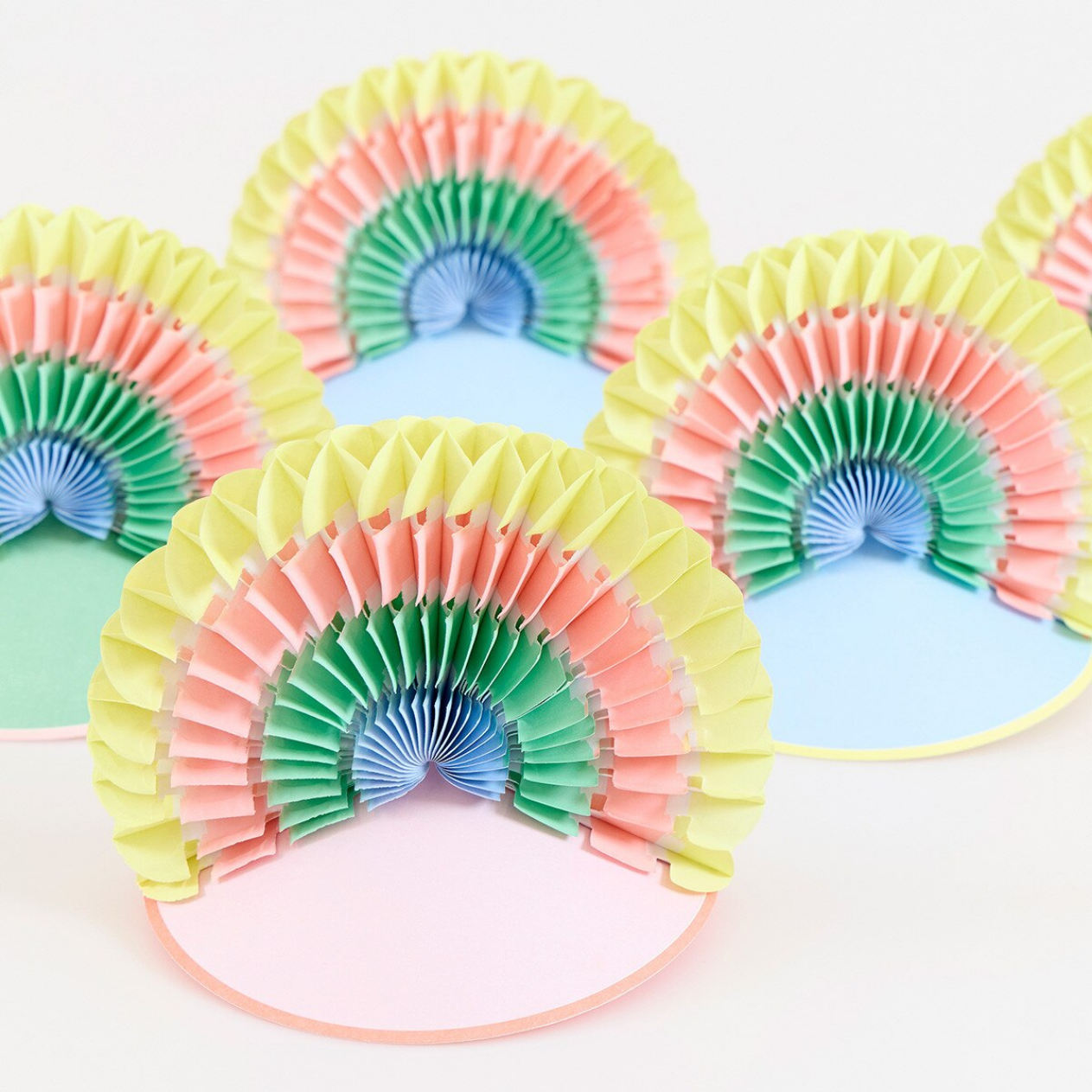 Colorful paper fan hats on a white background