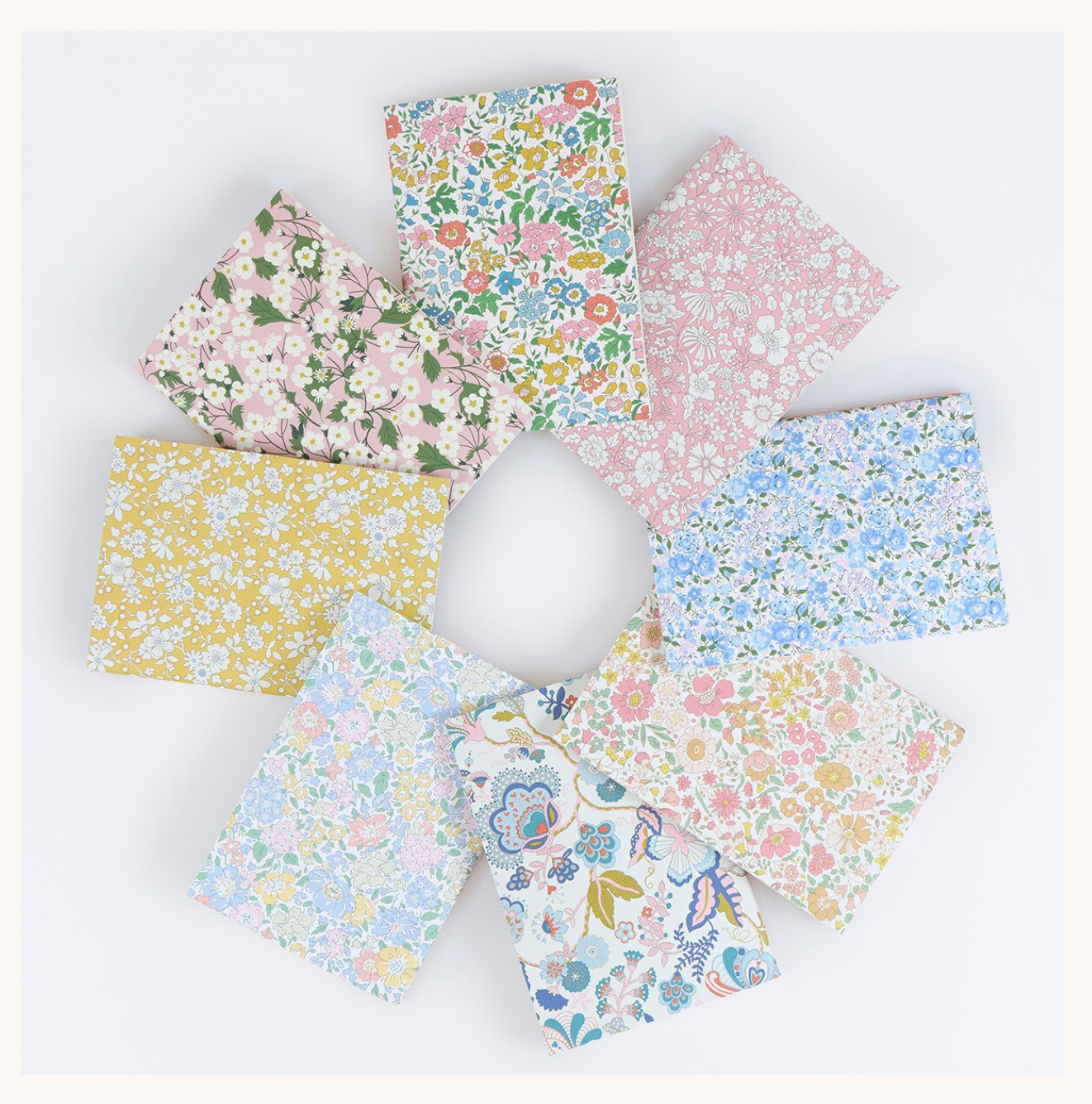 Set of floral fabric swatches arranged in a circular pattern on a white background