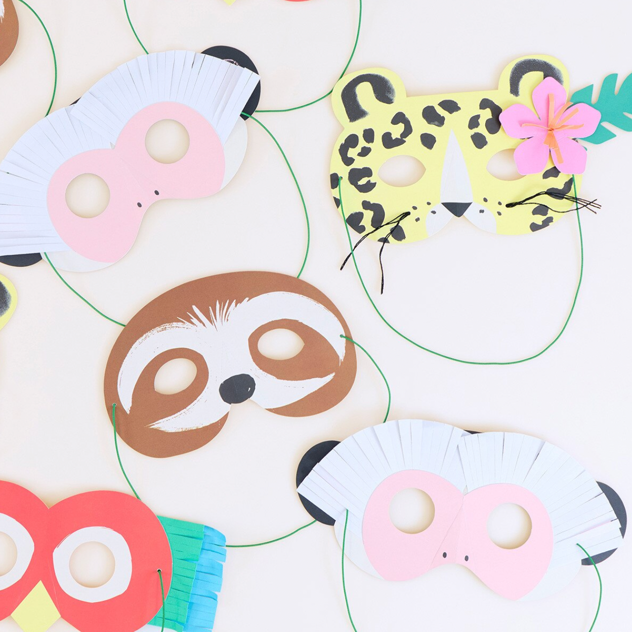 Set of animal-themed paper masks including a sloth, leopard, and owl on a white background.
