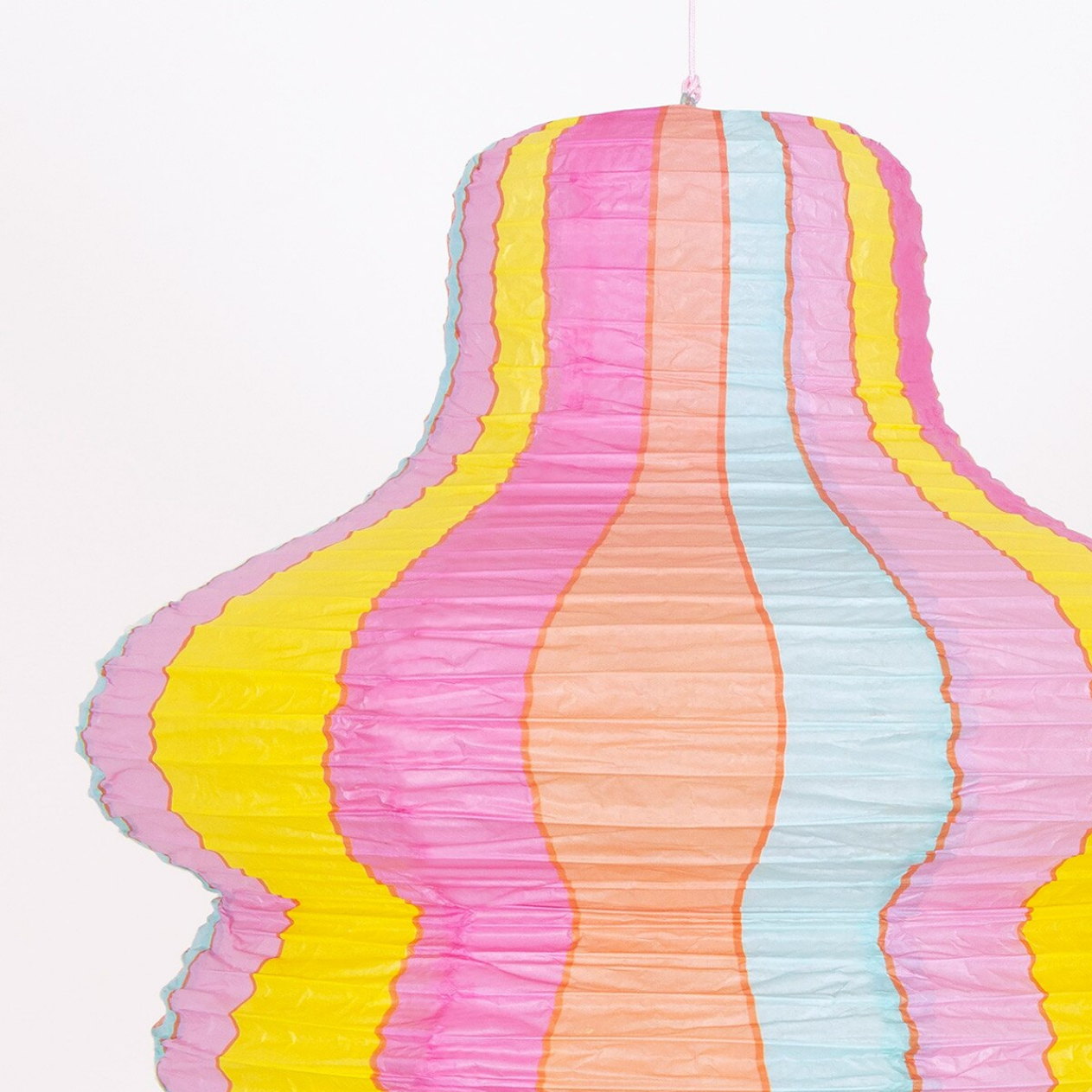 Colorful paper lantern with wavy pattern on a white background
