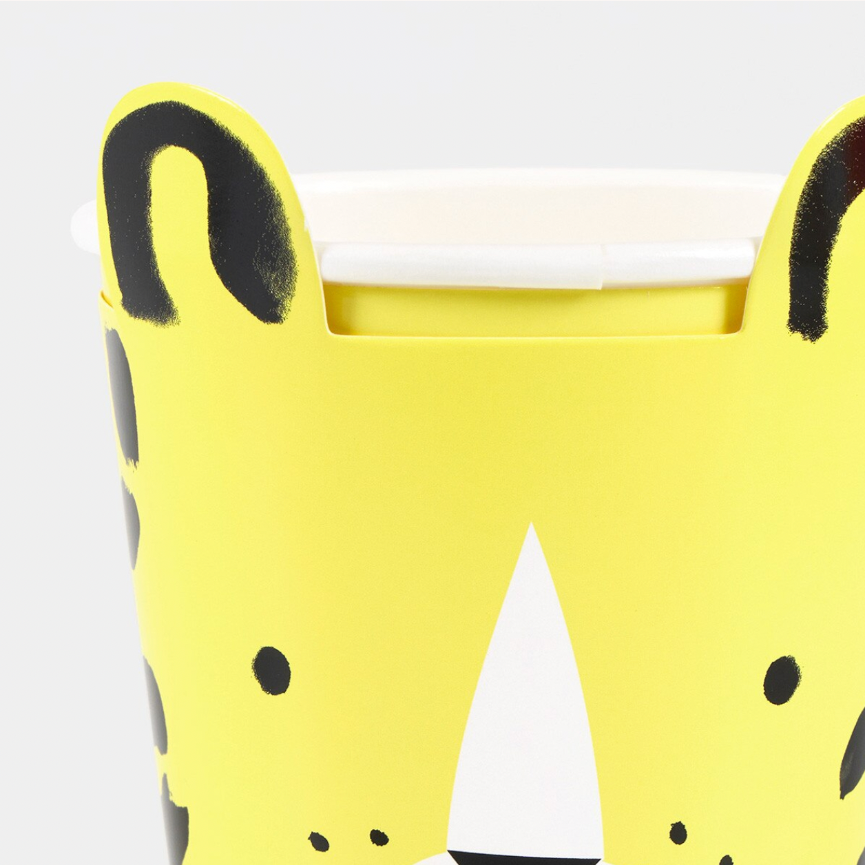 Yellow rubber duck with black spots on a white background