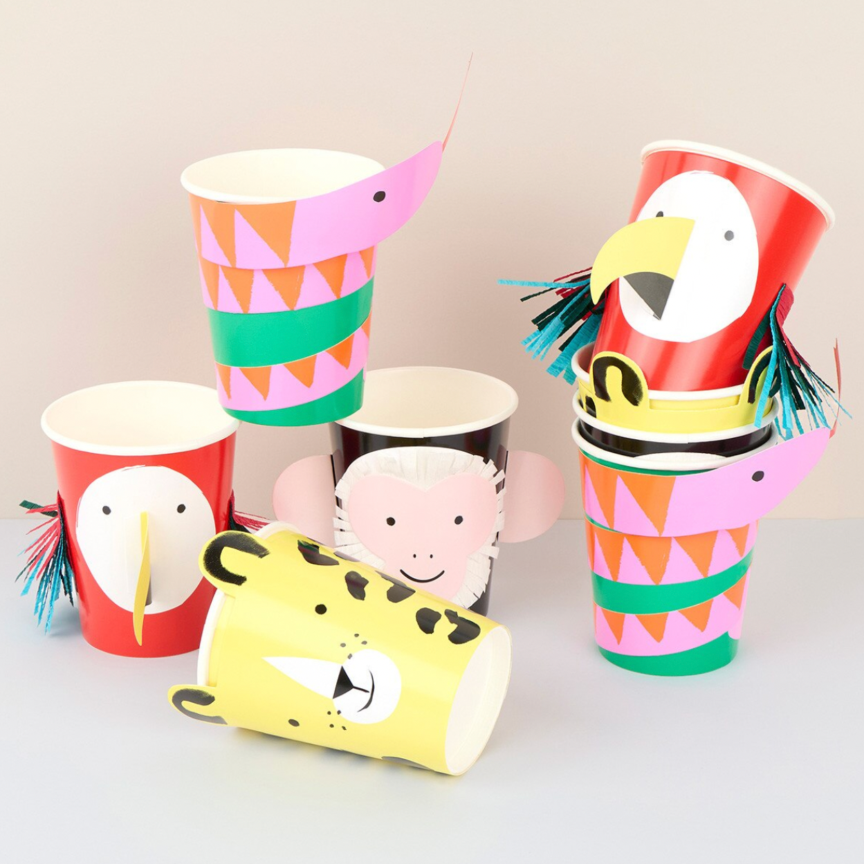 Colorful paper cups with animal designs on a light gray background