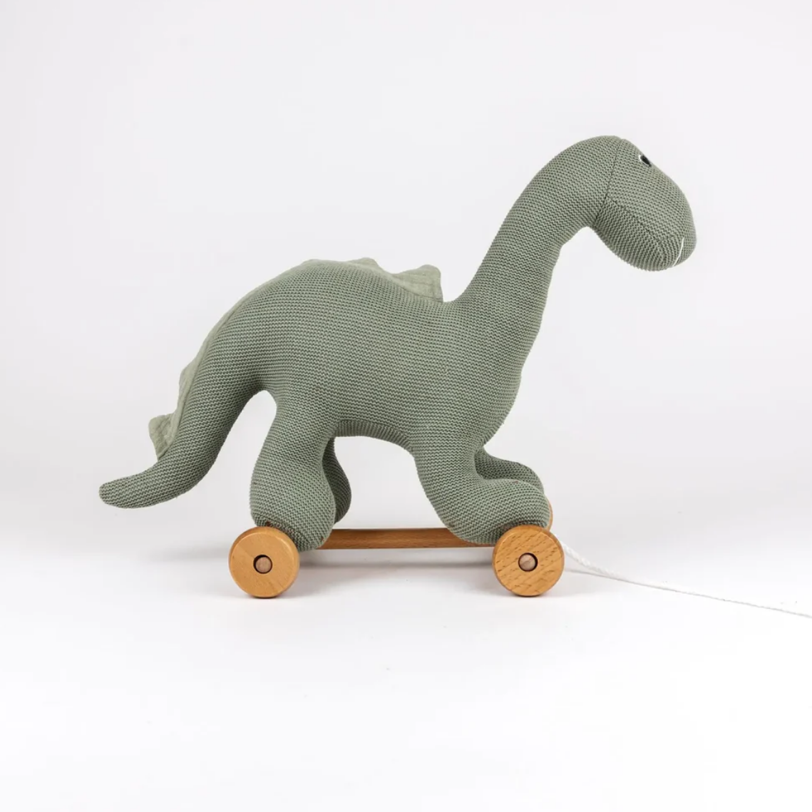Green dinosaur toy with wheels on a white background