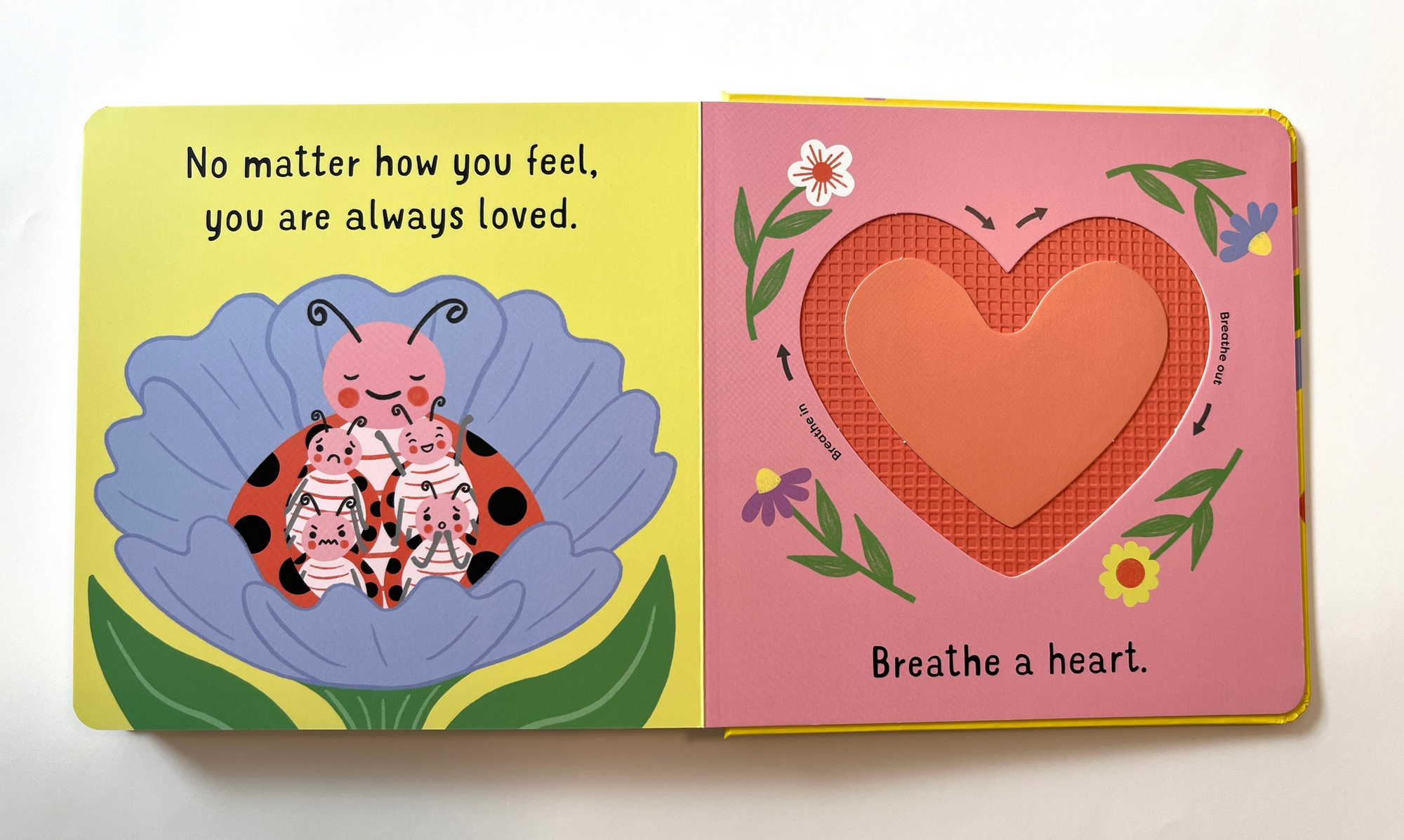Children's book with a ladybug and heart illustration on a white background
