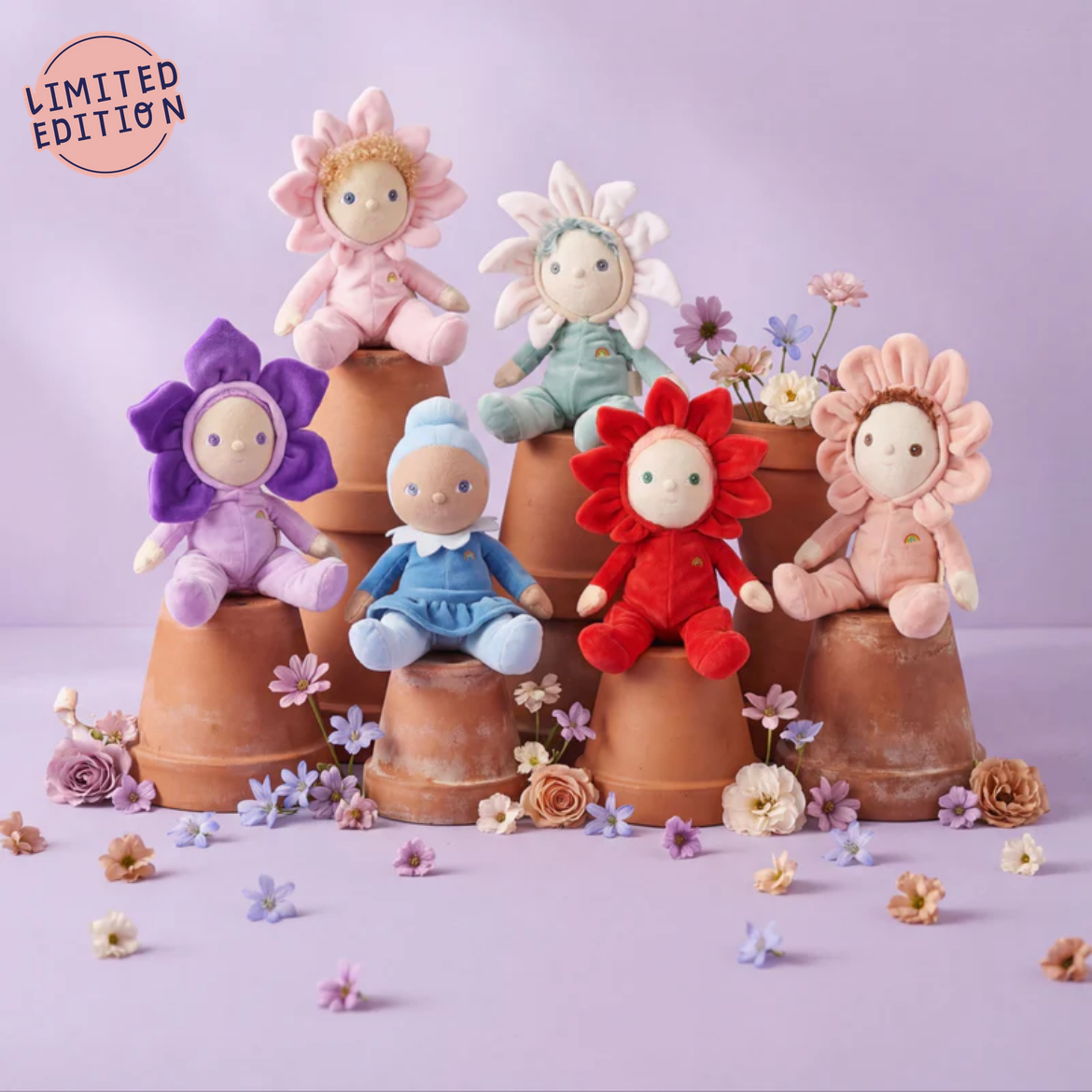 Set of colorful dolls in flower pots with a limited edition label on a light purple background.