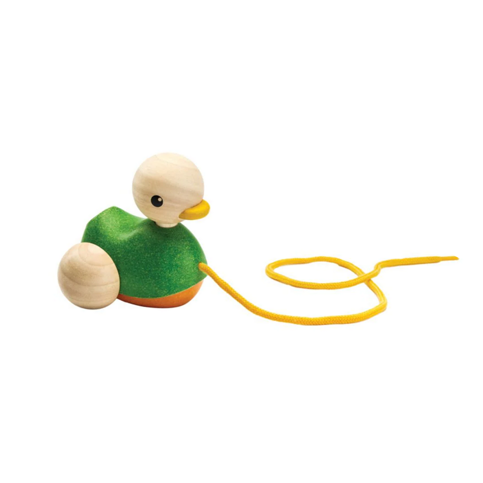 Wooden toy duck with a yellow string on a white background