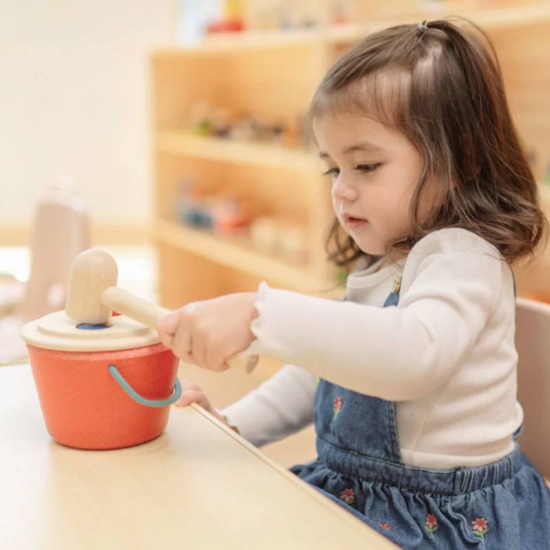 Child playing with a toy in a classroom setting