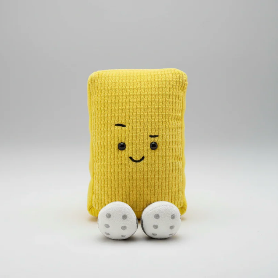 Yellow plush toy with a smiling face on a gray background