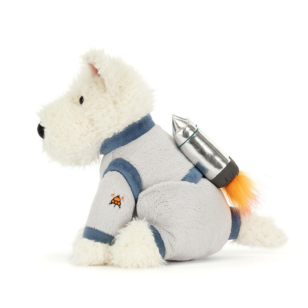 Stuffed toy dog in space suit with rocket on a white background