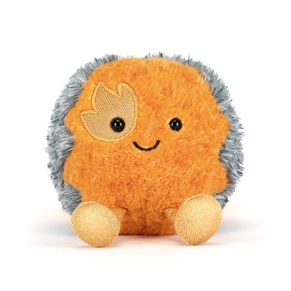 Plush toy resembling a space comet with a smiling face on a white background