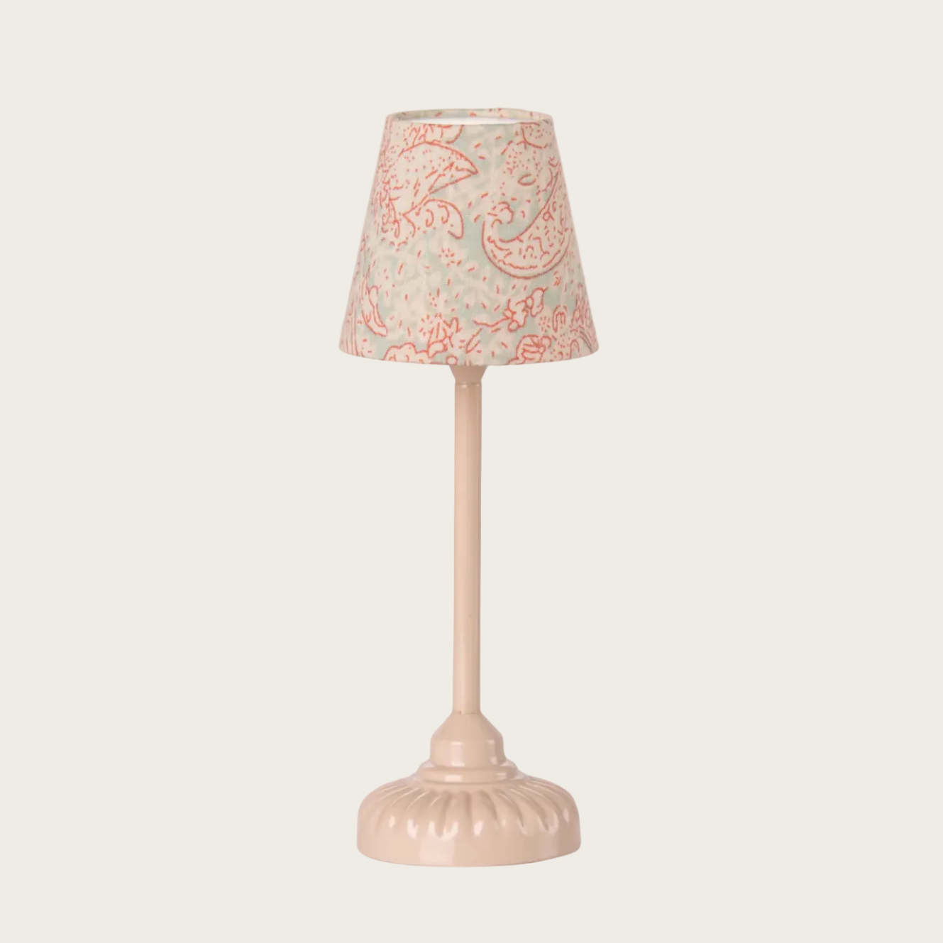 Small lamp with a decorative shade on a white background