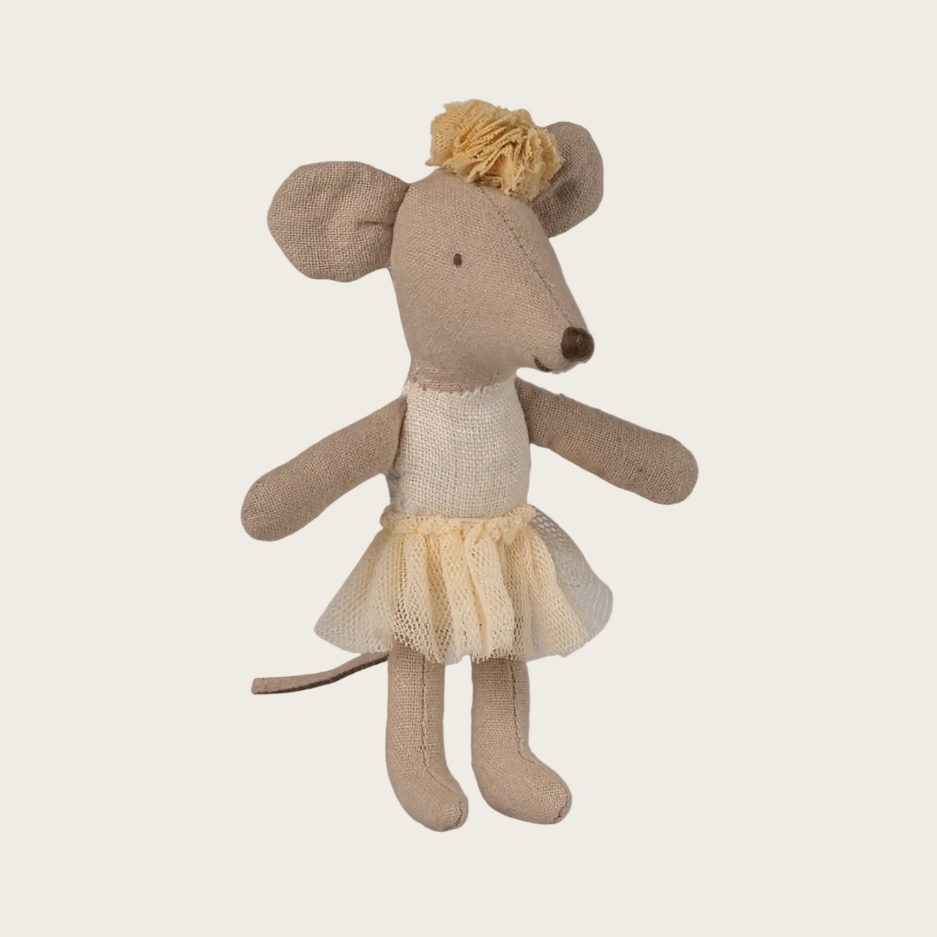 Stuffed toy mouse in a dress on a white background
