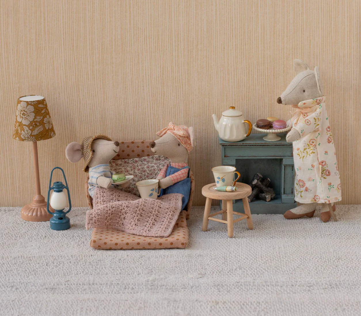 Miniature scene with toy furniture and figures in a room setting.