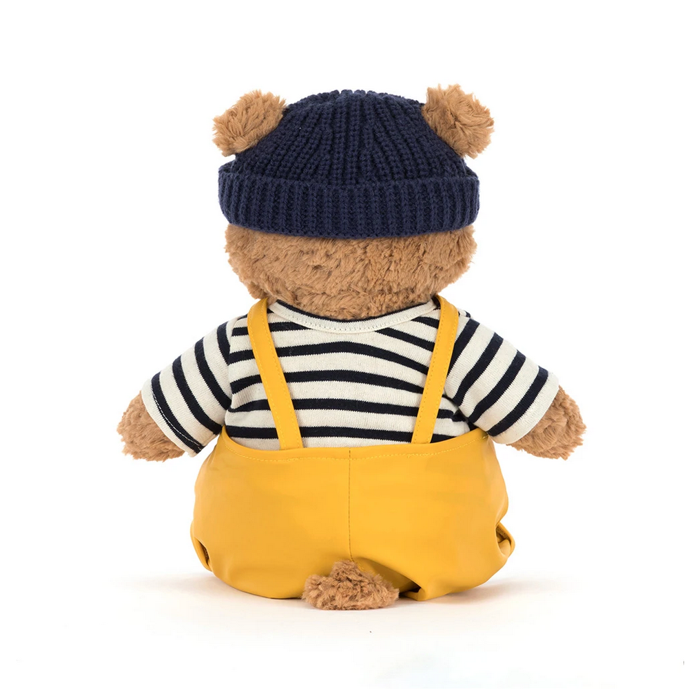 Teddy bear wearing a seafarer outfit with a navy hat on a white background