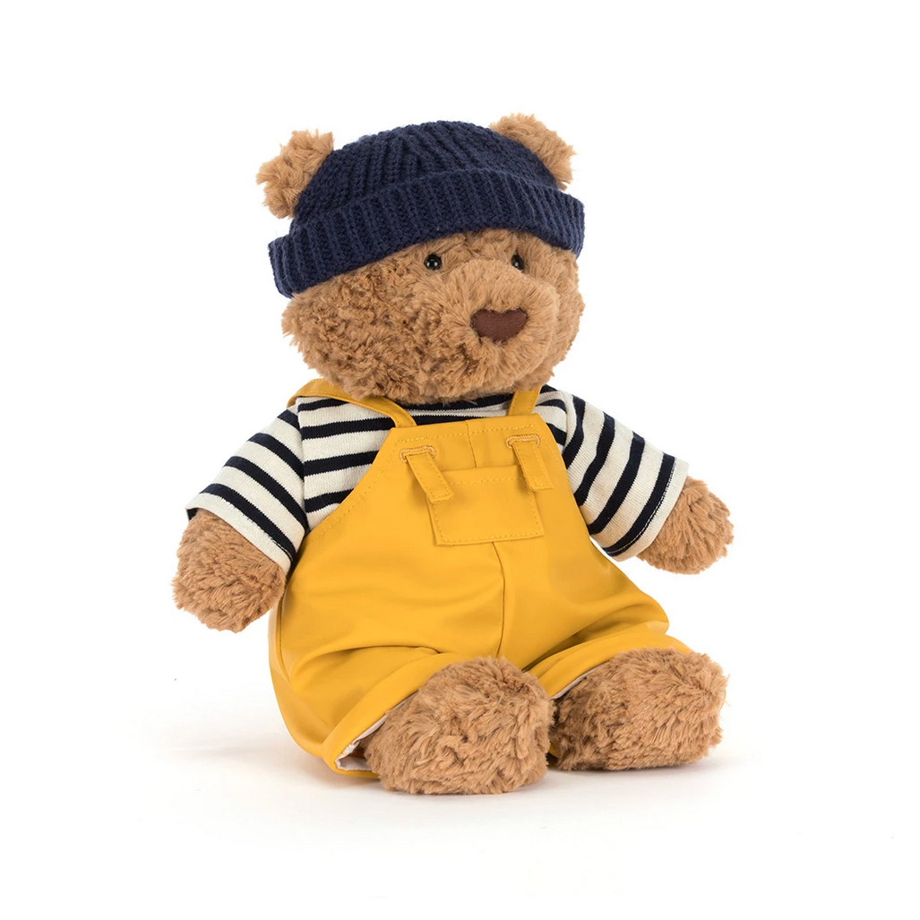 Teddy bear in a seafarer outfit with a navy hat on a white background