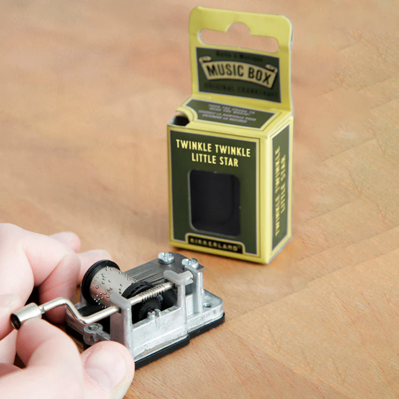 Music box with 'Twinkle Twinkle Little Star' text on a wooden surface