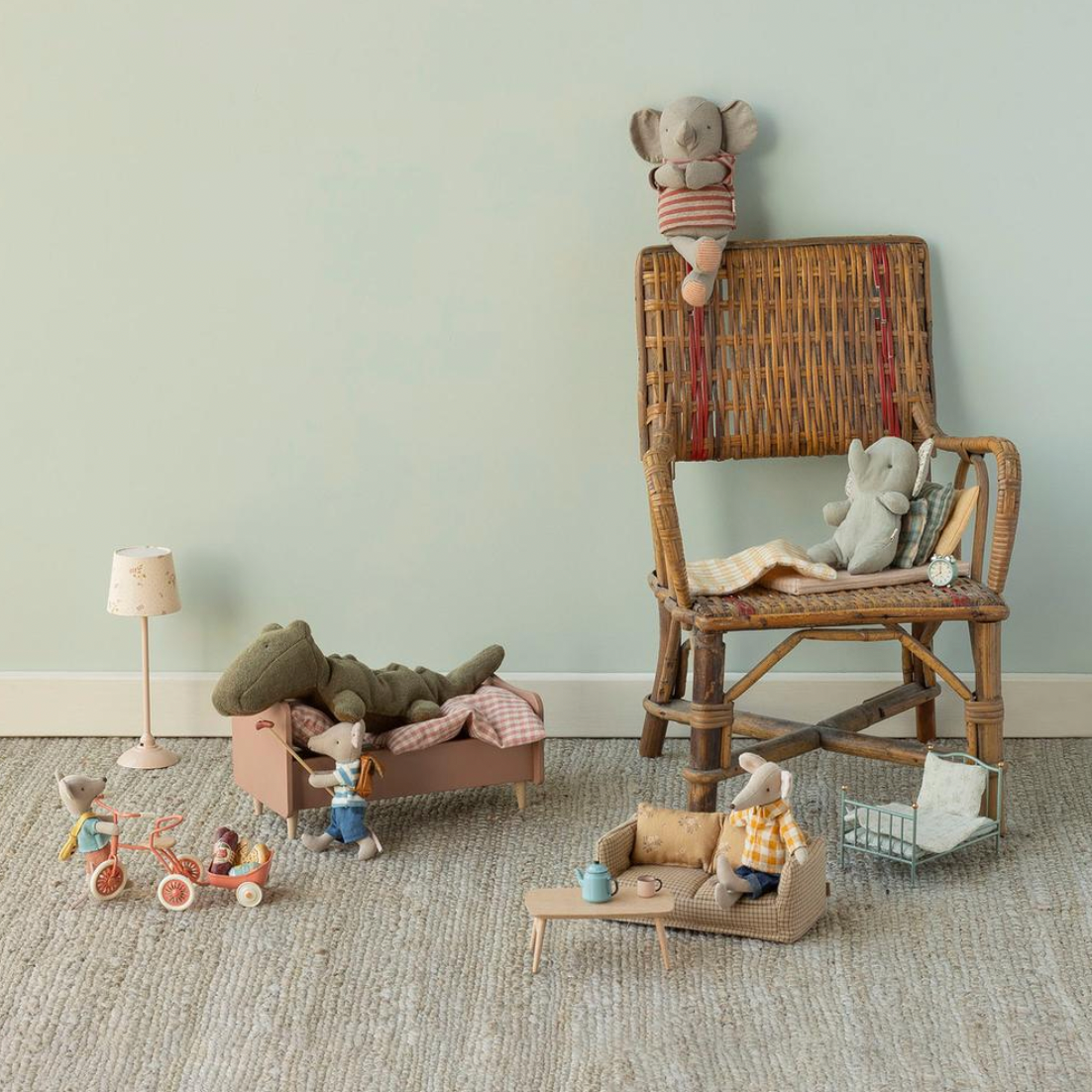 Children's toys and wooden chair in a room with light green walls.