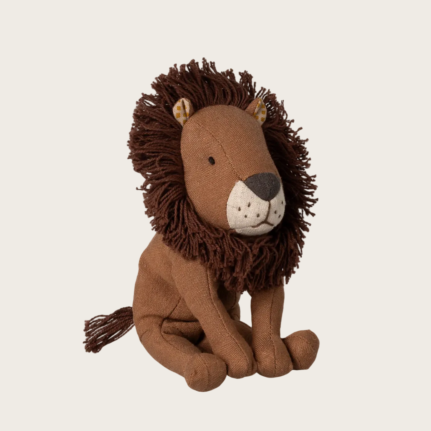 Stuffed lion toy on a website with product details.