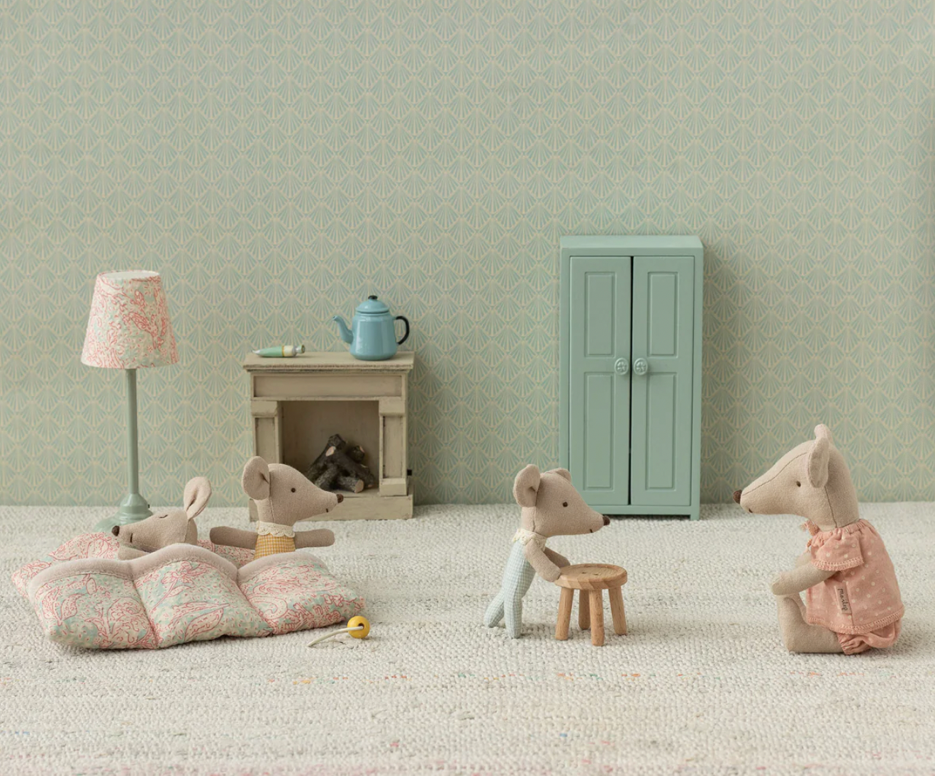 Toy mice in a room with furniture and decor, including a lamp, cabinet, and fireplace.