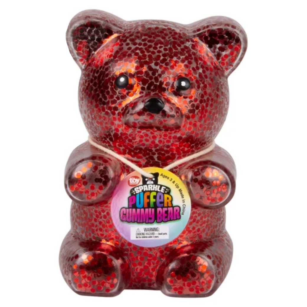 Red glittery gummy bear with a label on a white background