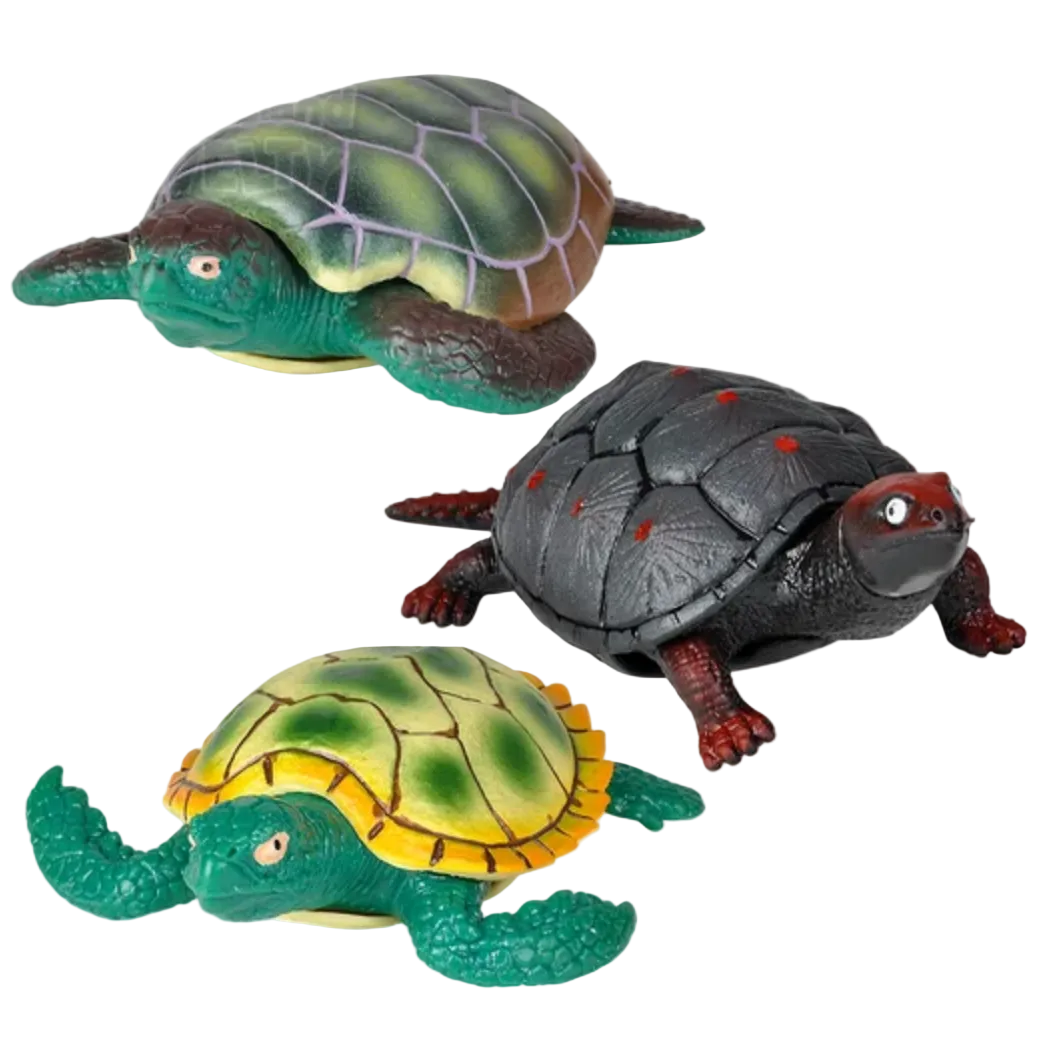 Three toy turtles in different colors on a white background