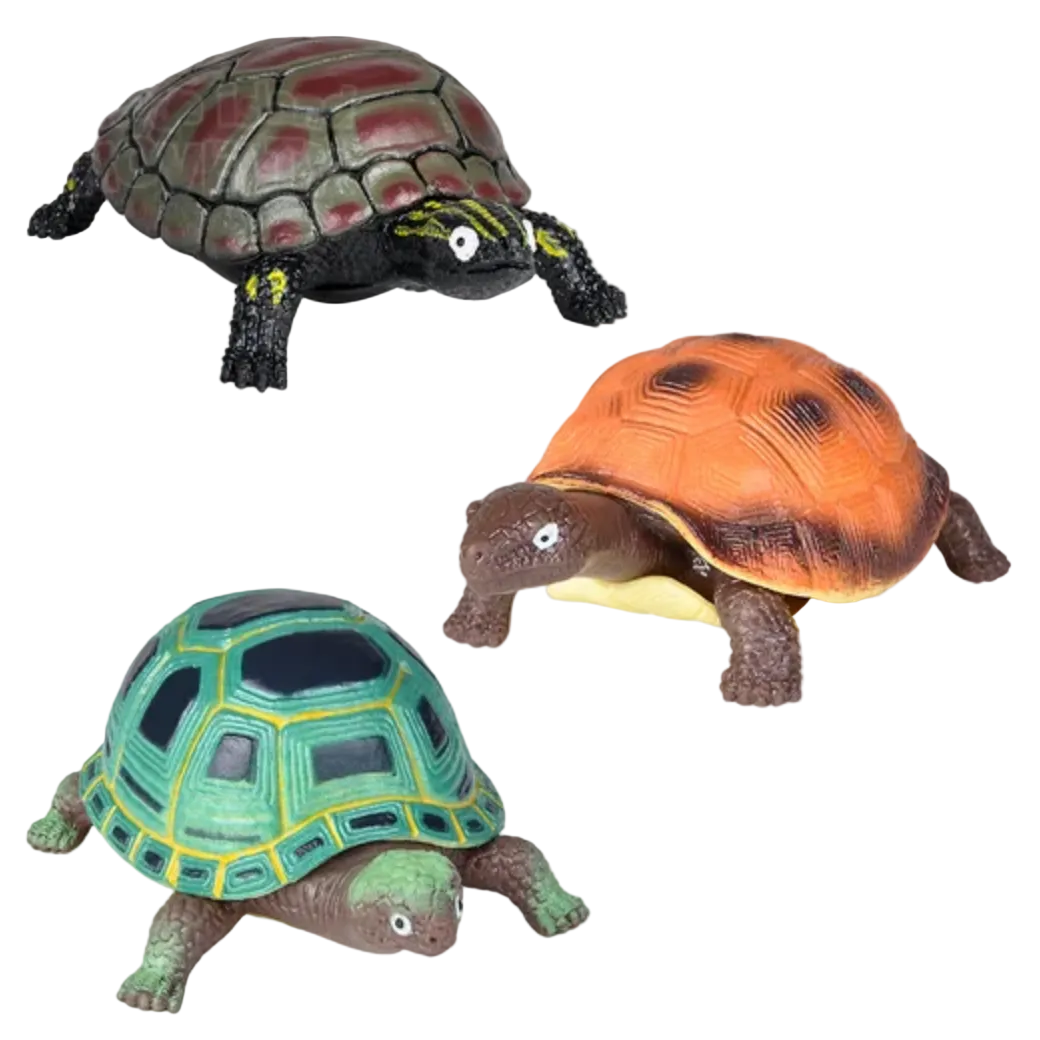 Three turtle figurines in different colors on a white background